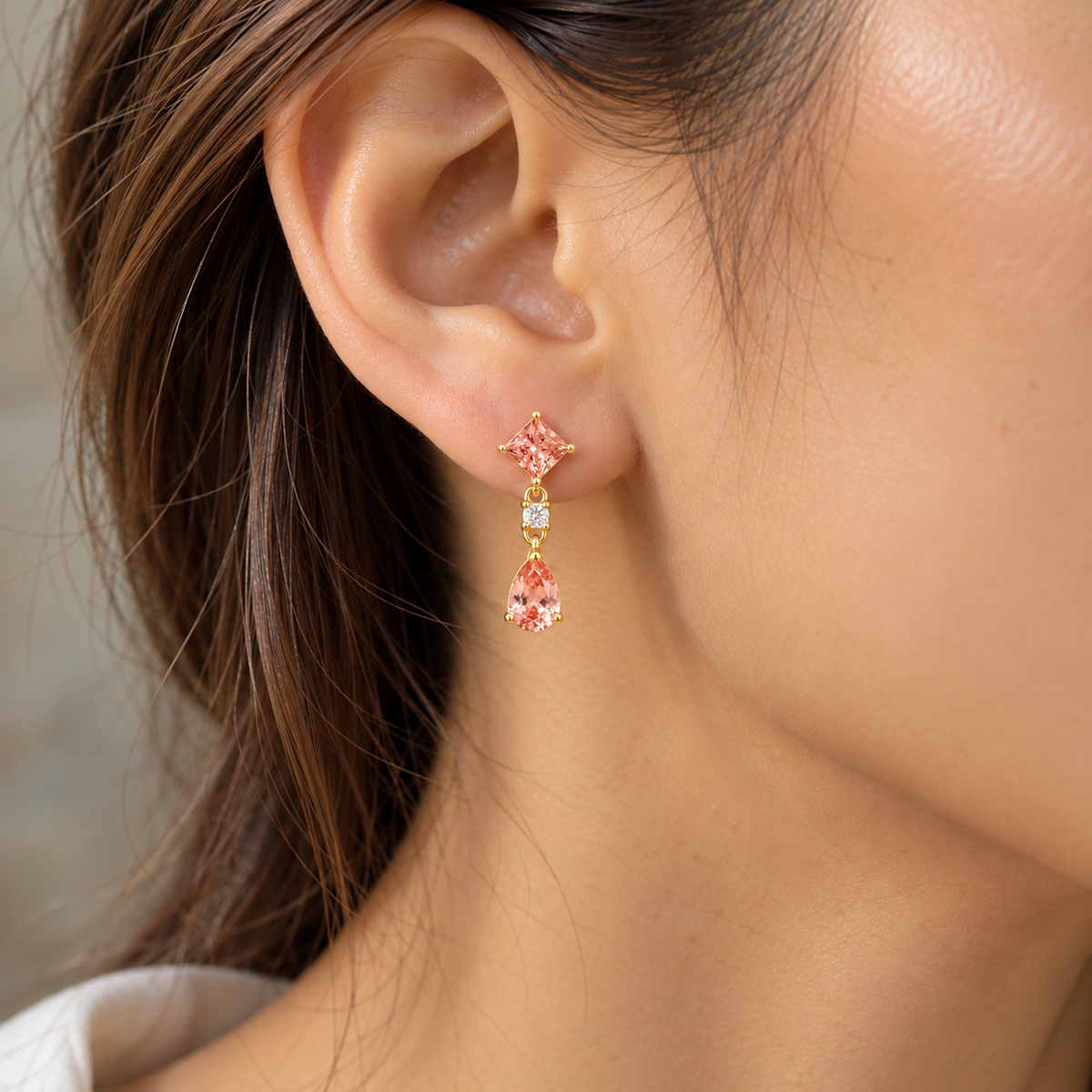 Model wears the Flamingo Padparadscha Sapphire & Diamond Drop Earrings in Gold