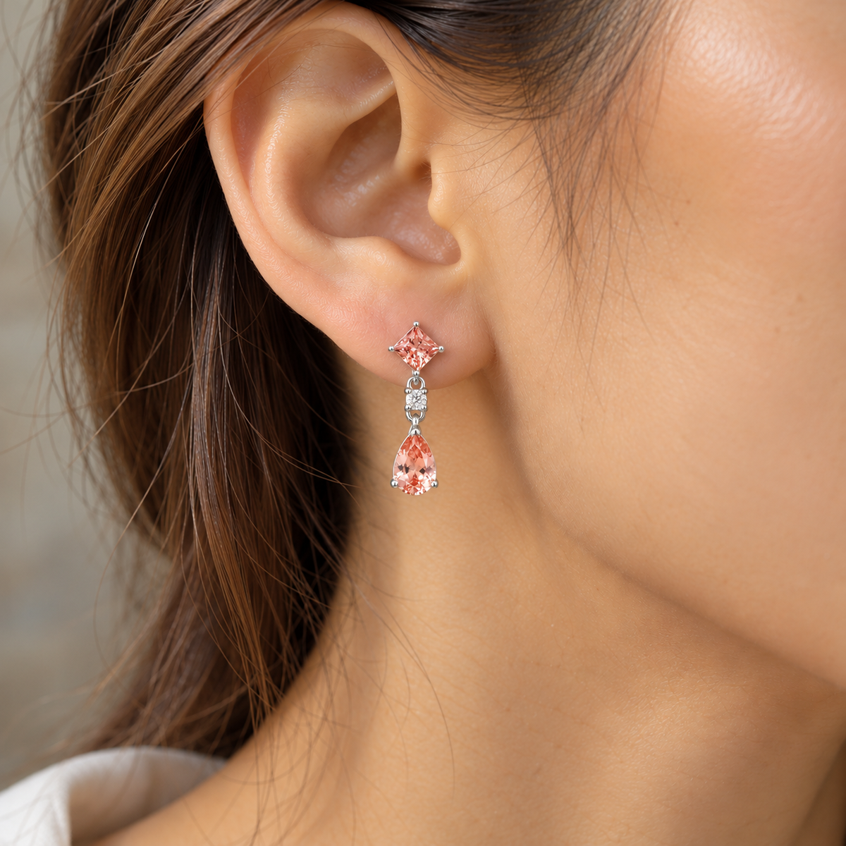 Model wears the Flamingo Padparadscha Sapphire & Diamond Drop Earrings in White Gold