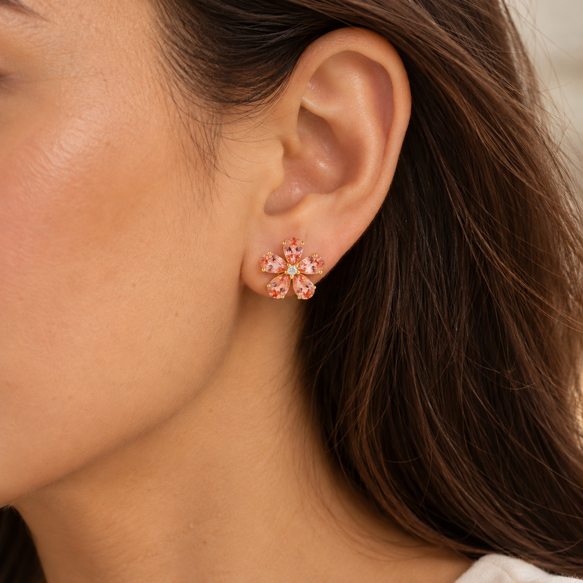 Model wears the Florea Padparadscha Sapphire & Diamond Flower Stud Earrings in Gold