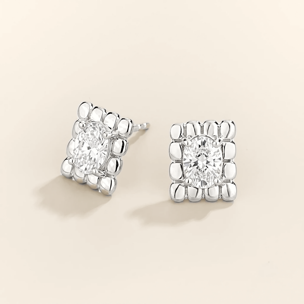 Fondi oval lab-grown diamond sculpted stud earrings in white gold – angle view | Juvetti London