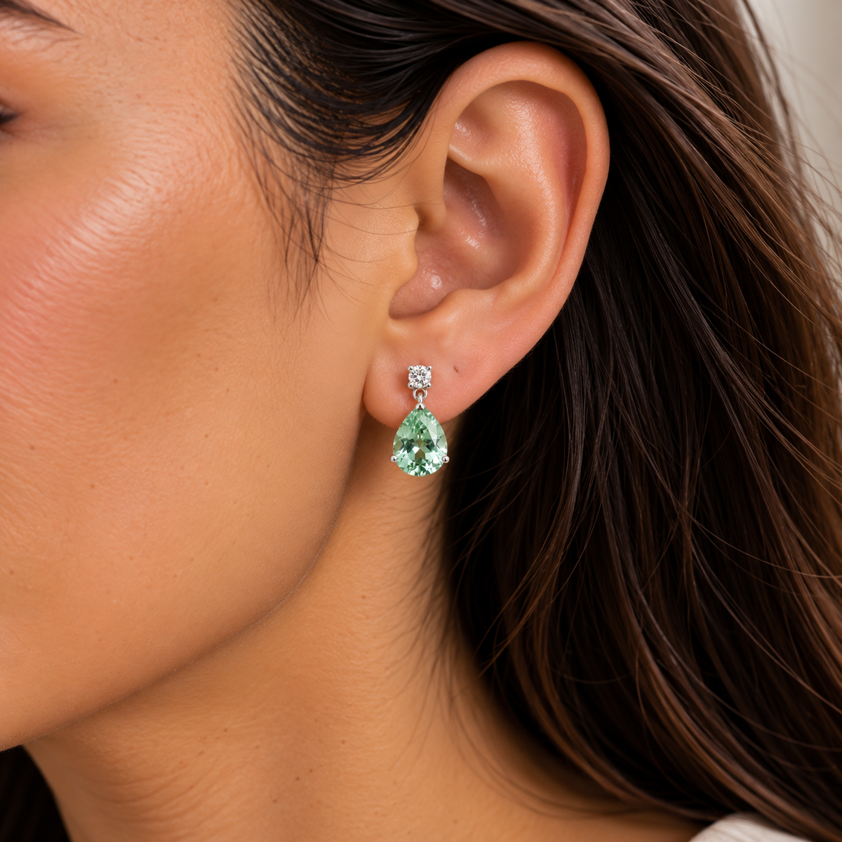 Model wears the Pisa Green Sapphire & Diamond Pear Drop Earrings in White Gold – Medium