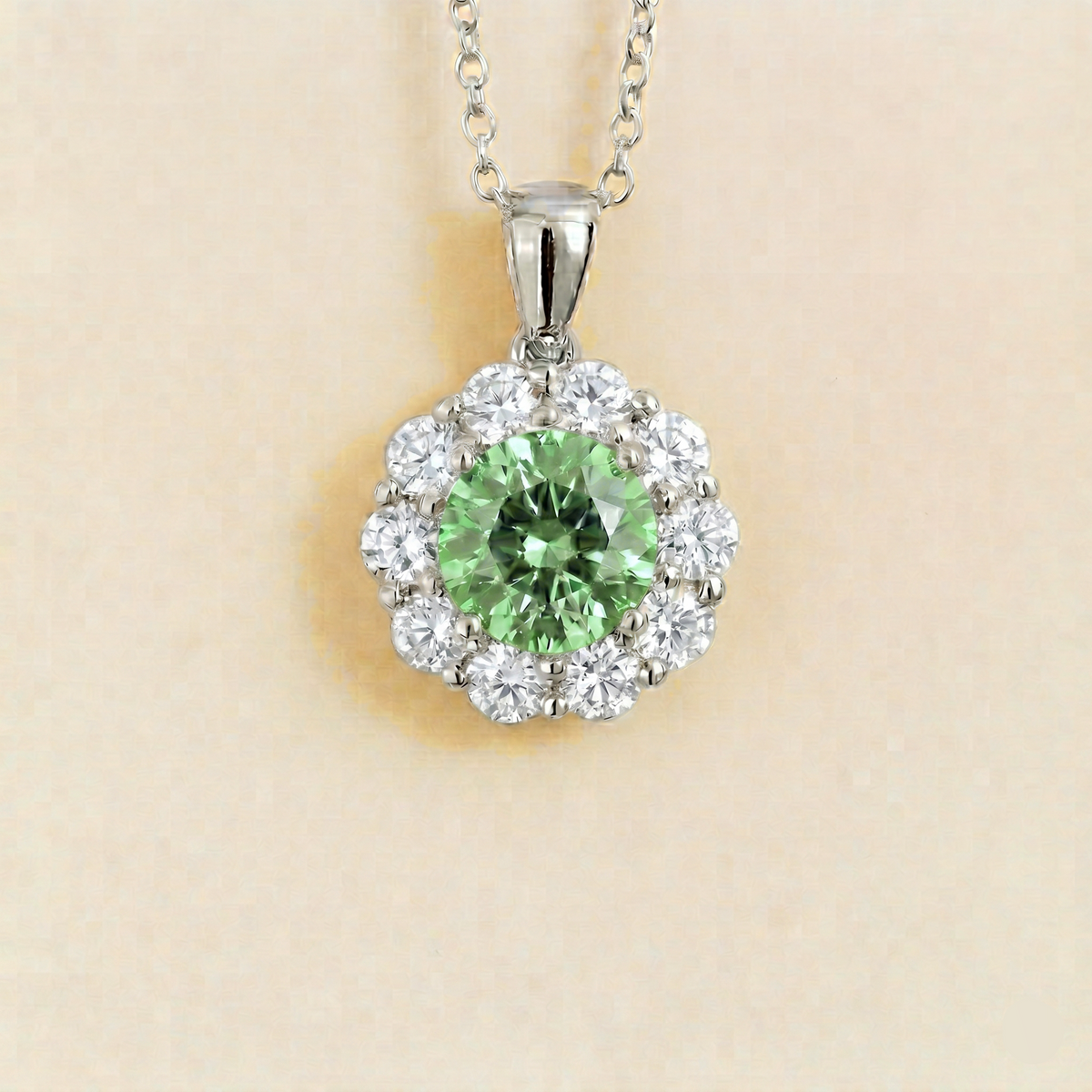 Floret round lab-grown green sapphire and diamond halo pendant necklace in white gold – front | Juvetti London