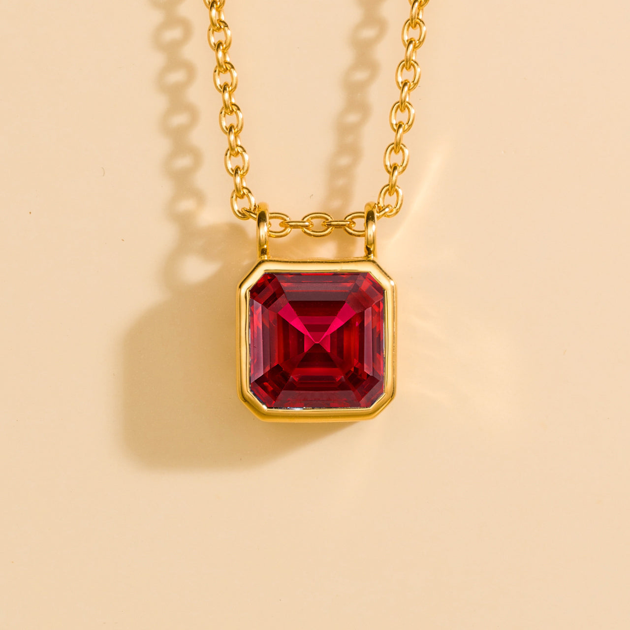 Juvetti yellow gold pendant necklace featuring an Asscher-cut lab-grown ruby.