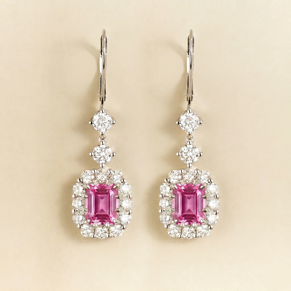 Pippa emerald-cut pink sapphire and diamond halo drop earrings in white gold, lab-grown sapphires hanging from round diamonds on lever-back hooks