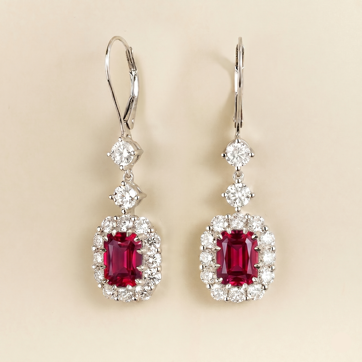 Pippa emerald-cut ruby and diamond halo drop earrings in white gold, lab-grown rubies hanging from round diamonds on lever-back hooks, side view