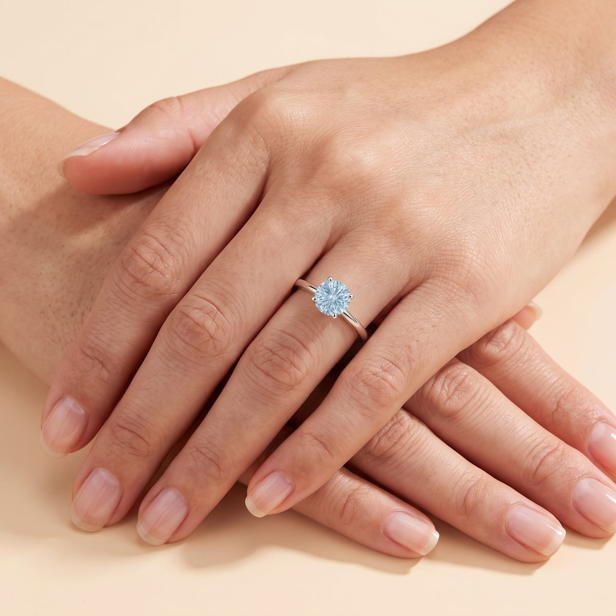 Model wearing the Nina Round Shape Aquamarine Cathedral Solitaire Ring in White Gold