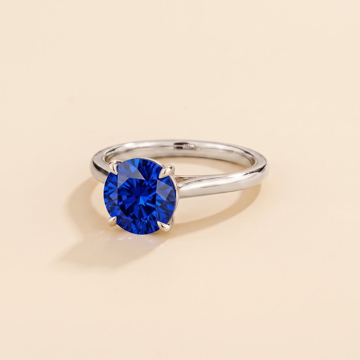 Nina Round Shape Blue Sapphire Cathedral Solitaire Ring in White Gold, three-quarter view