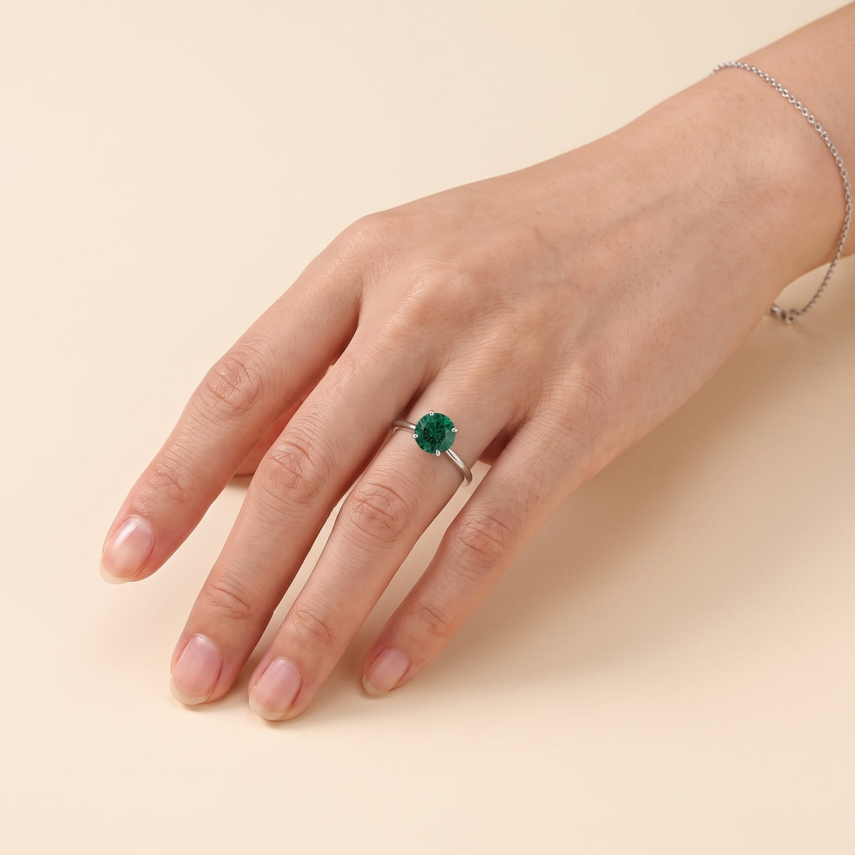 Model wearing the Nina Round Shape Emerald Cathedral Solitaire Ring in White Gold