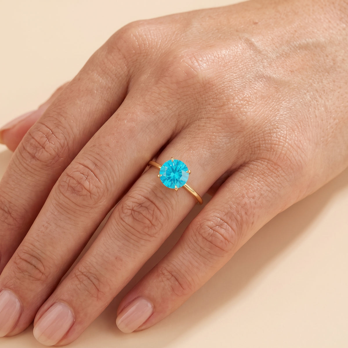 Model wearing the Nina Round Shape Paraiba Sapphire Cathedral Solitaire Ring in Gold