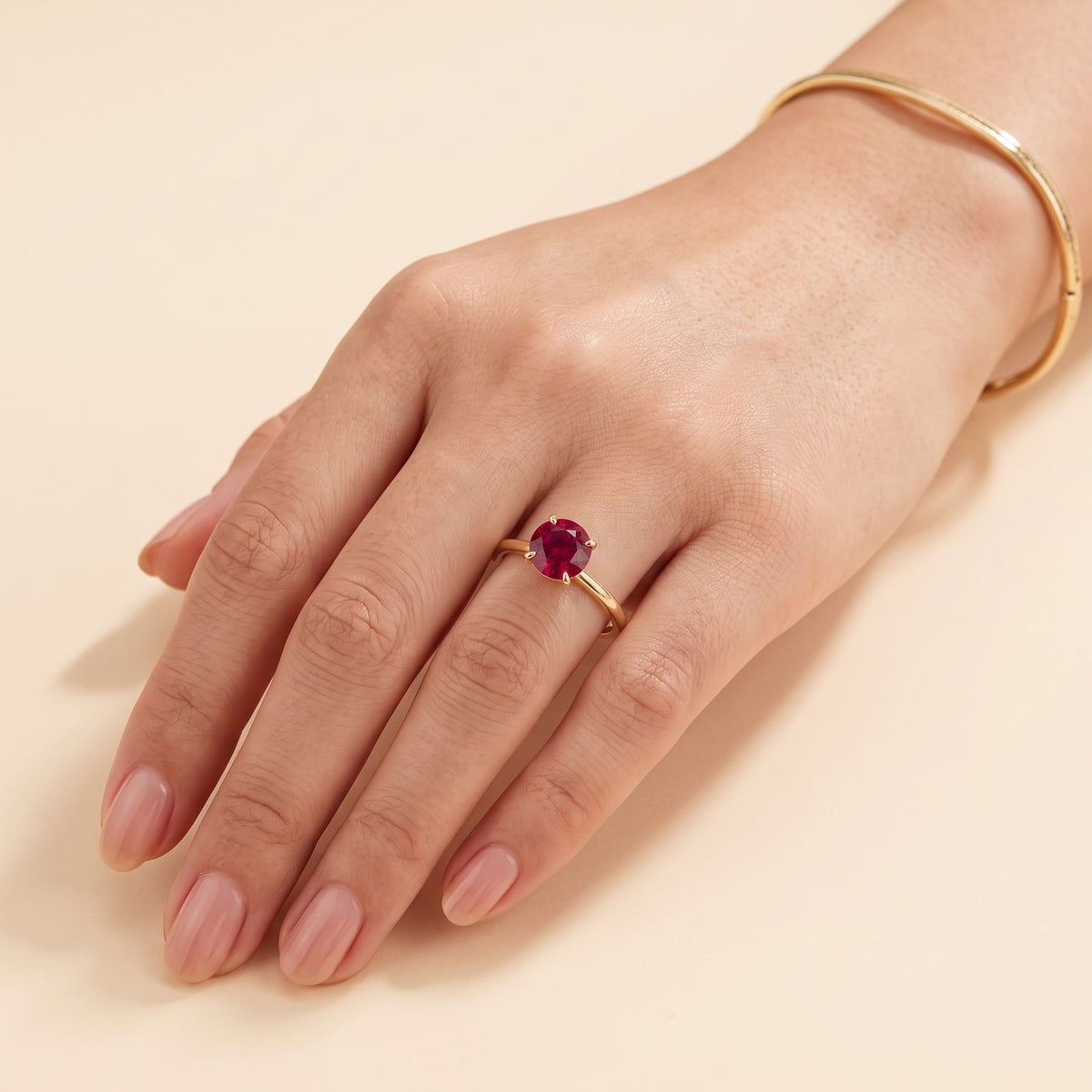 Model wearing the Nina Round Shape Ruby Cathedral Solitaire Ring in Gold