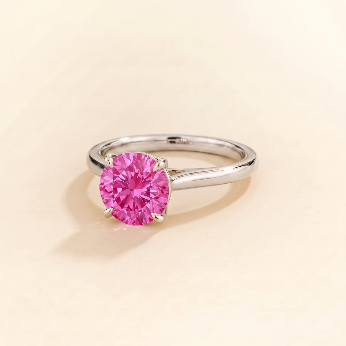 Nina Round Shape Vivid Pink Sapphire Cathedral Solitaire Ring in White Gold, three-quarter view