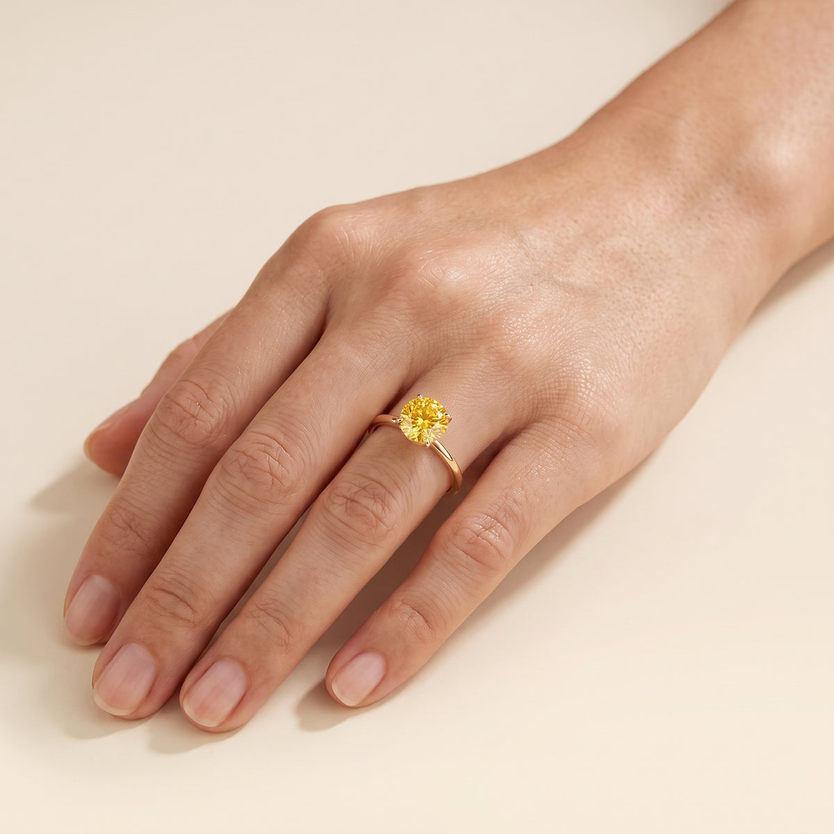 Model wearing the Nina Round Shape Yellow Sapphire Cathedral Solitaire Ring in Gold