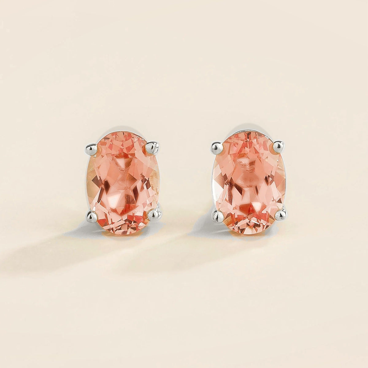 Ovo padparadscha sapphire oval solitaire stud earrings in white gold