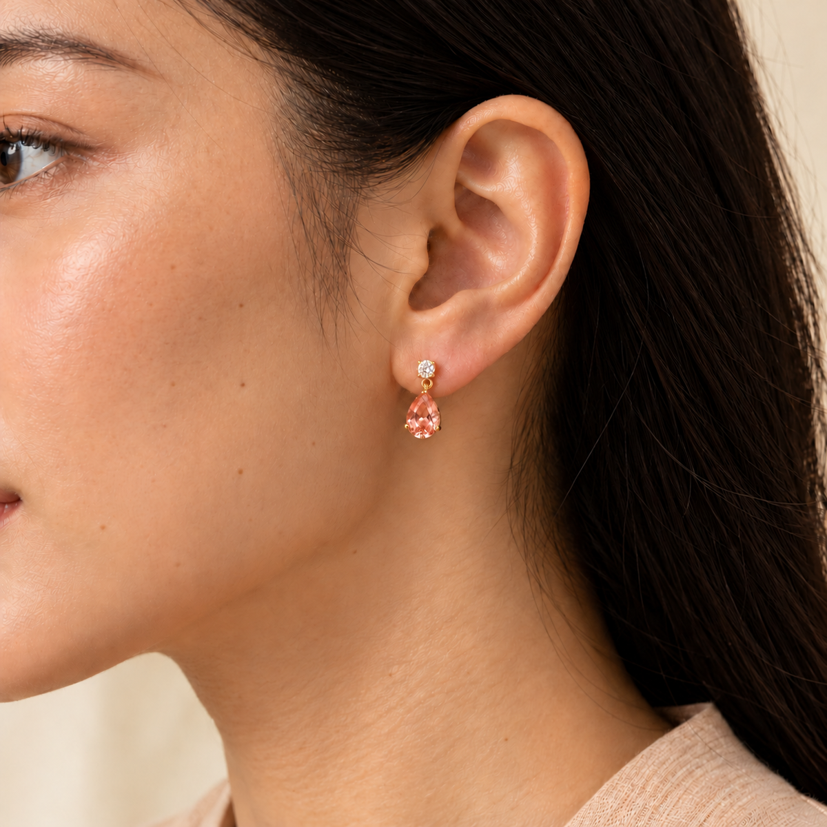 Medium lab-grown Padparadscha sapphire and diamond pear drop earrings in gold worn on model | Pisa by Juvetti