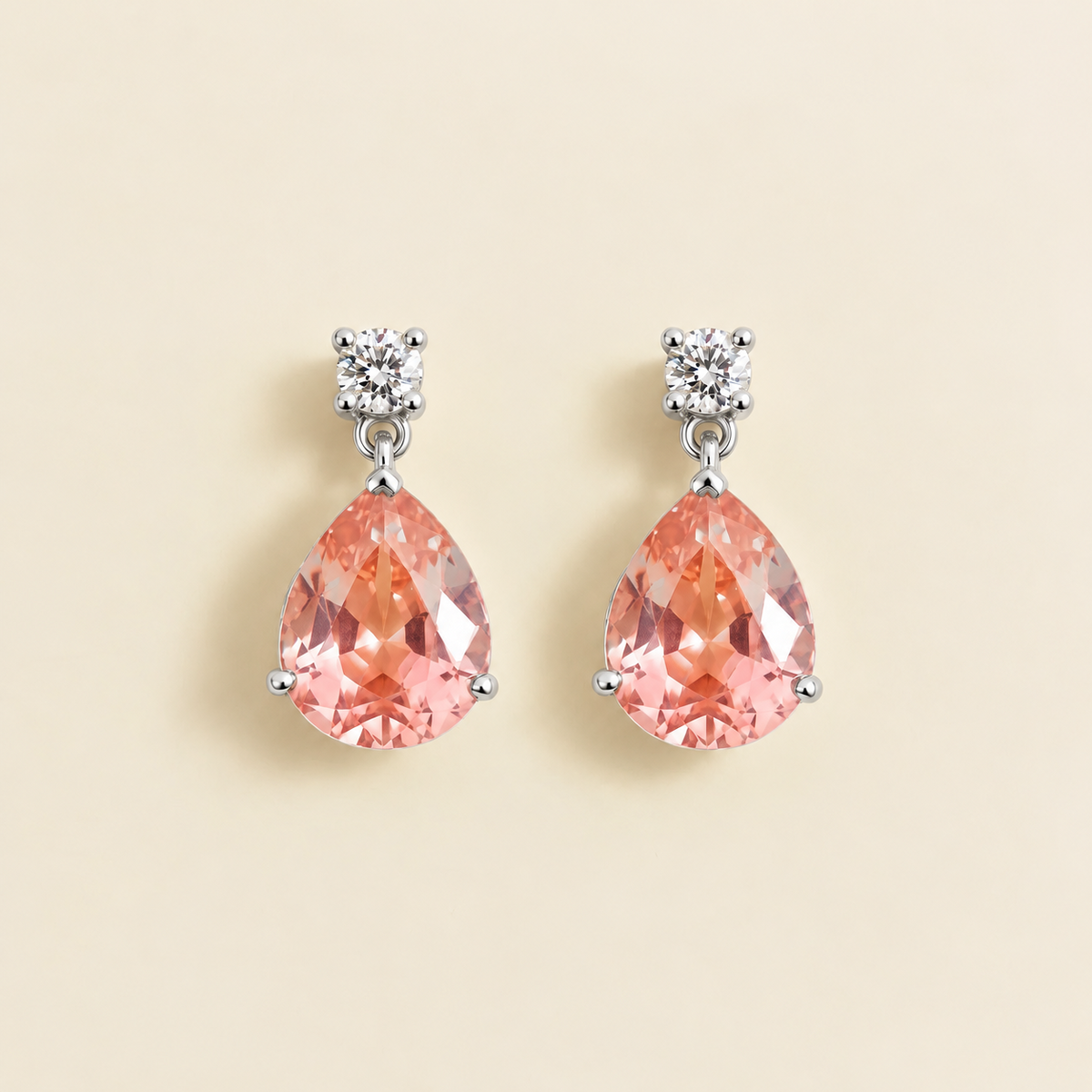 Medium lab-grown Padparadscha sapphire and diamond pear drop earrings in white gold – front view | Pisa by Juvetti