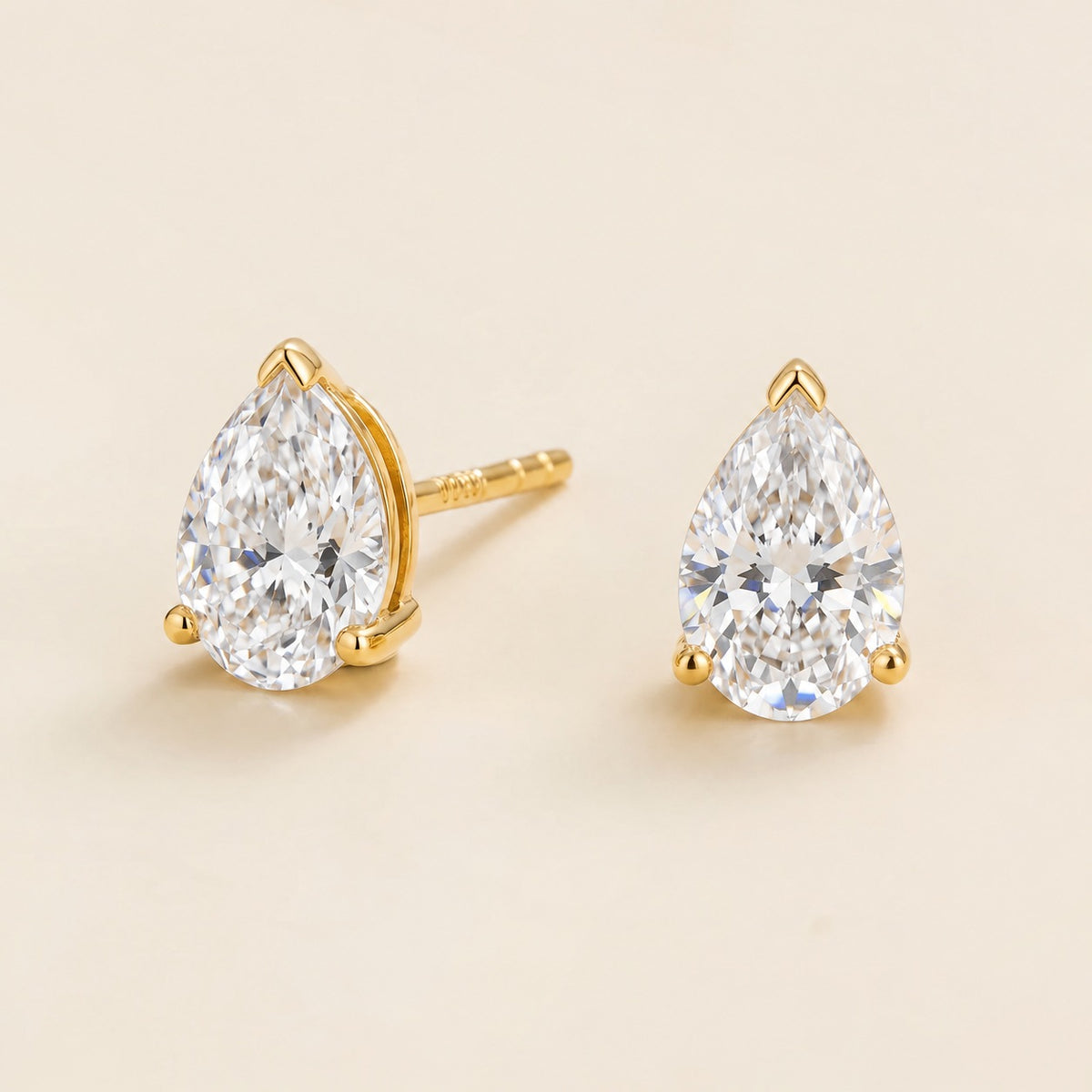 Pandal pear lab-grown diamond solitaire stud earrings in gold – angled view | Juvetti