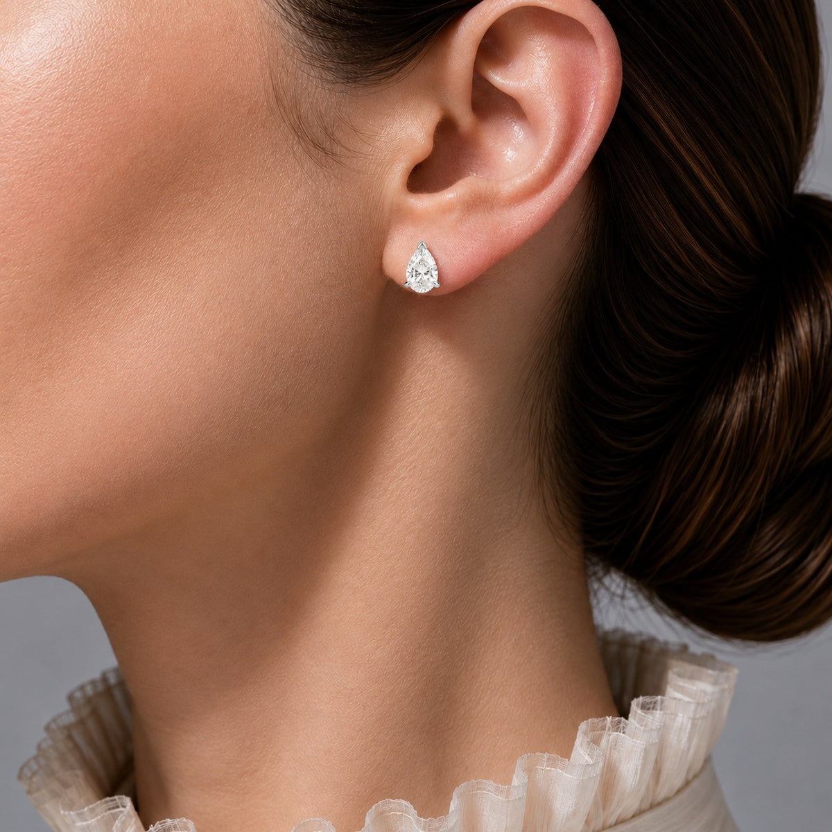 Pandal pear lab-grown diamond solitaire stud earrings in white gold – on model | Juvetti