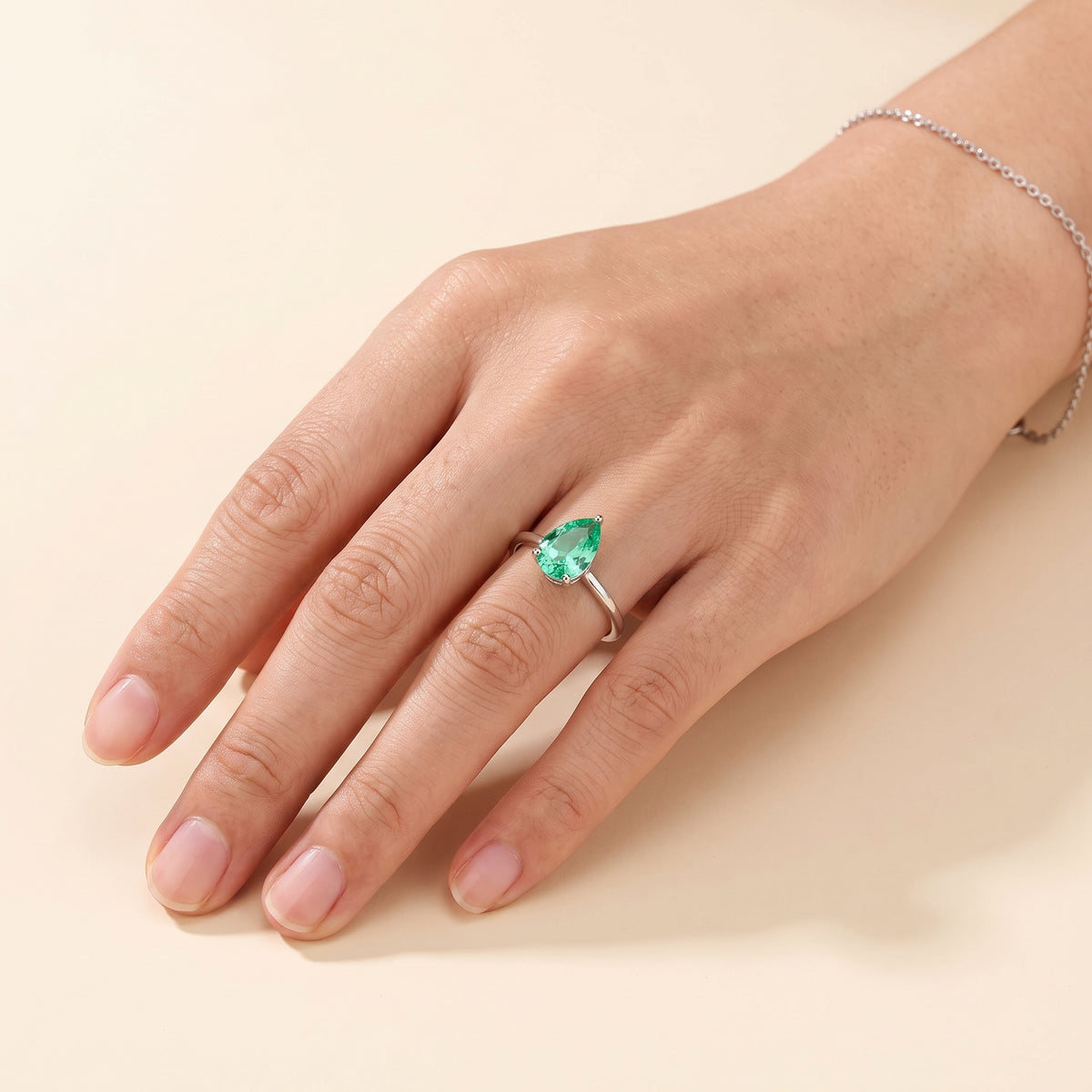 Model wearing the Pandal Pear Shape Green Sapphire Cathedral Solitaire Ring in White Gold
