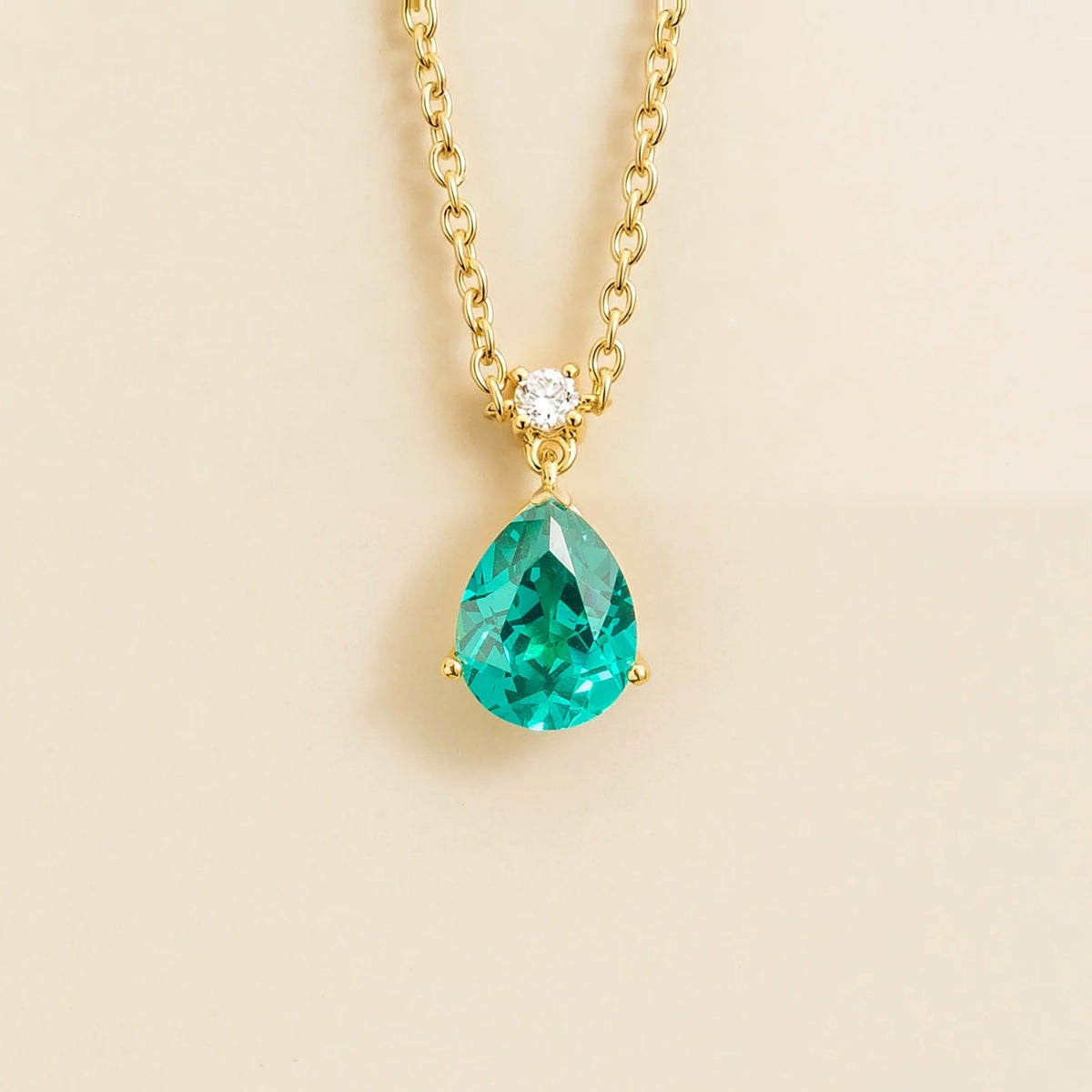 Lab-grown Paraiba sapphire and diamond pear drop pendant necklace in gold, medium – front view | Pisa by Juvetti