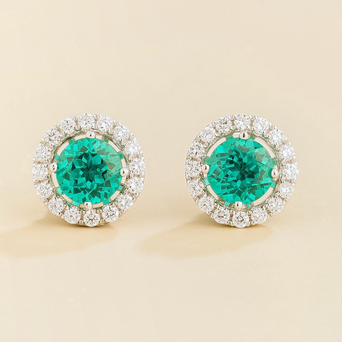 Floret round lab-grown paraiba sapphire and diamond halo stud earrings in white gold – front | Juvetti London