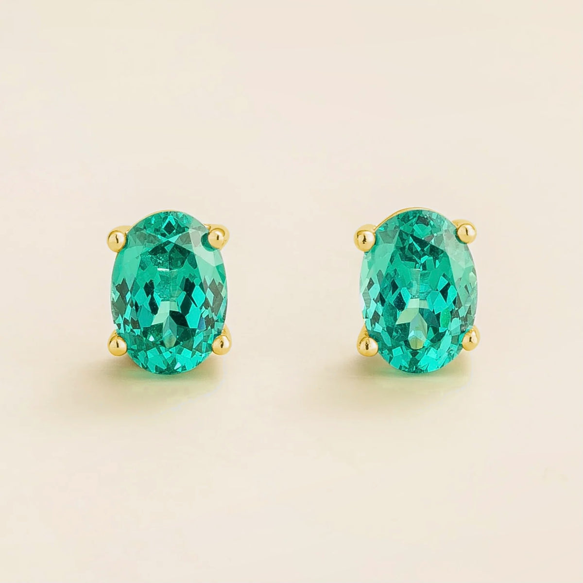 Ovo paraiba sapphire oval solitaire stud earrings in gold