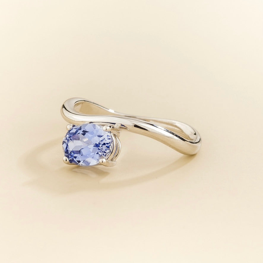 Luno pastel blue sapphire oval ring in white gold, lab-grown sapphire set east-west, angled view | Juvetti London