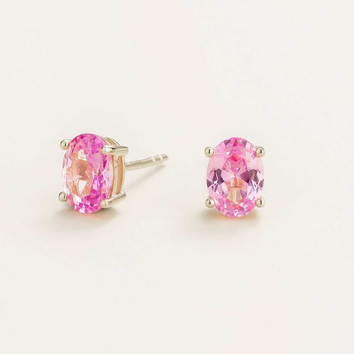 Oval pink sapphire stud earrings in solitaire design set in white gold