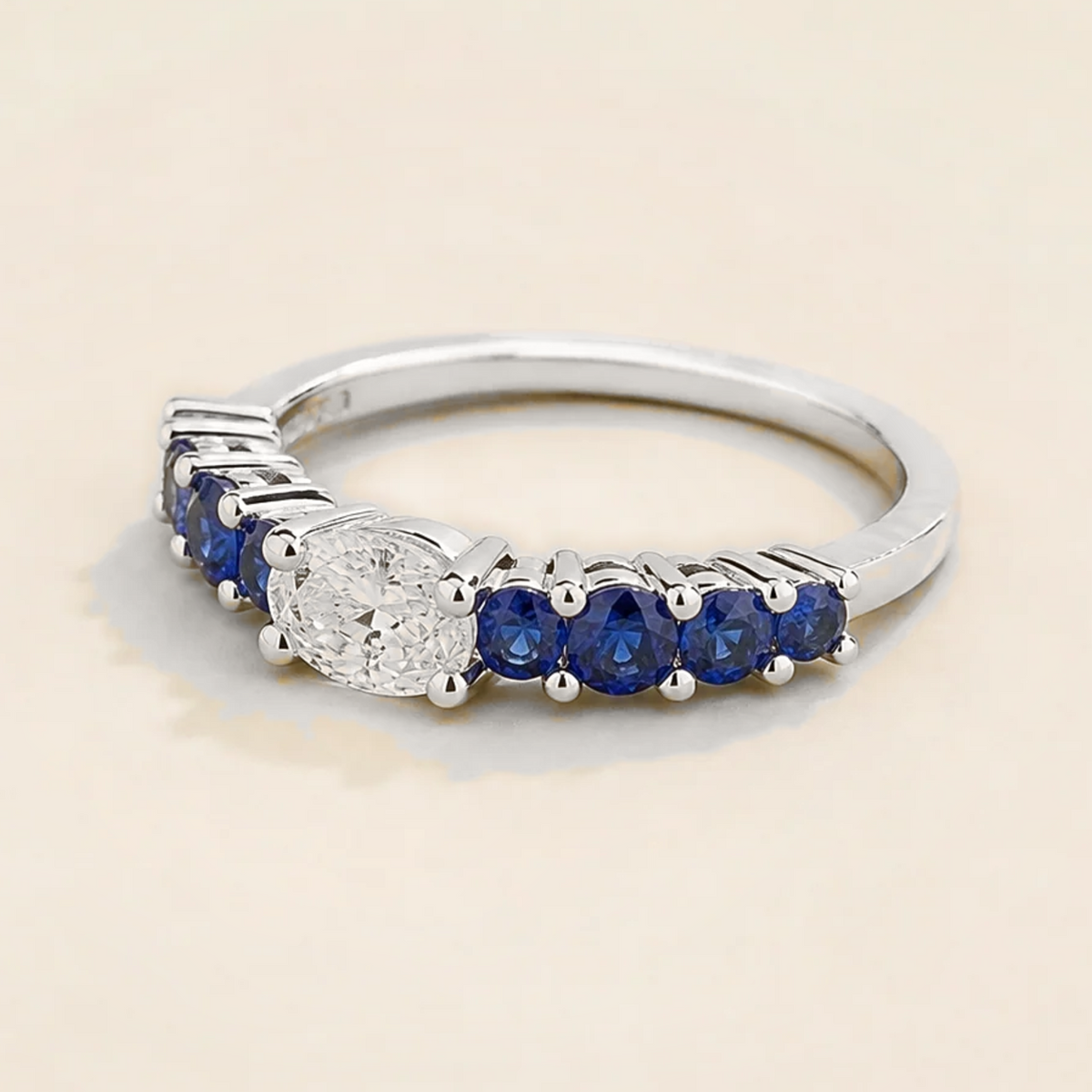 Petra Oval Diamond and Blue Sapphire Half Eternity Ring in White Gold Angle view