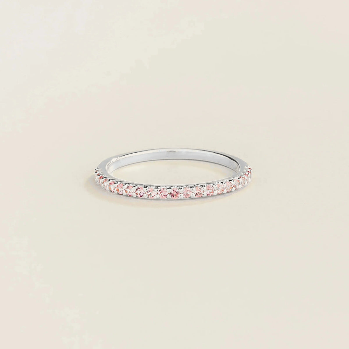Juvetti white gold half eternity band set with round lab-grown pink sapphires.