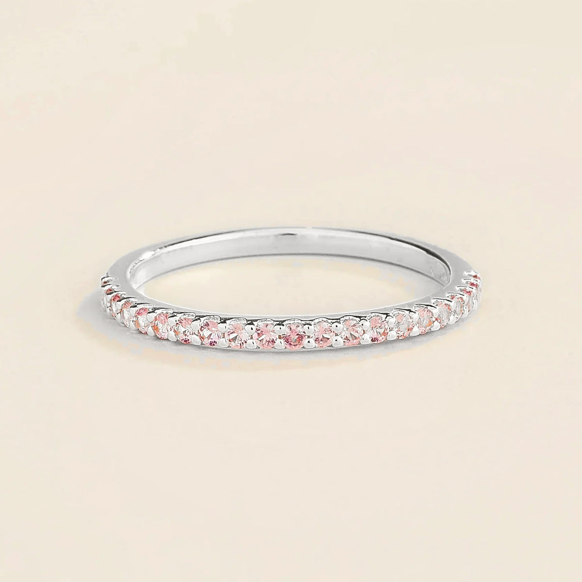 Juvetti white gold half eternity band set with round lab-grown pink sapphires.
