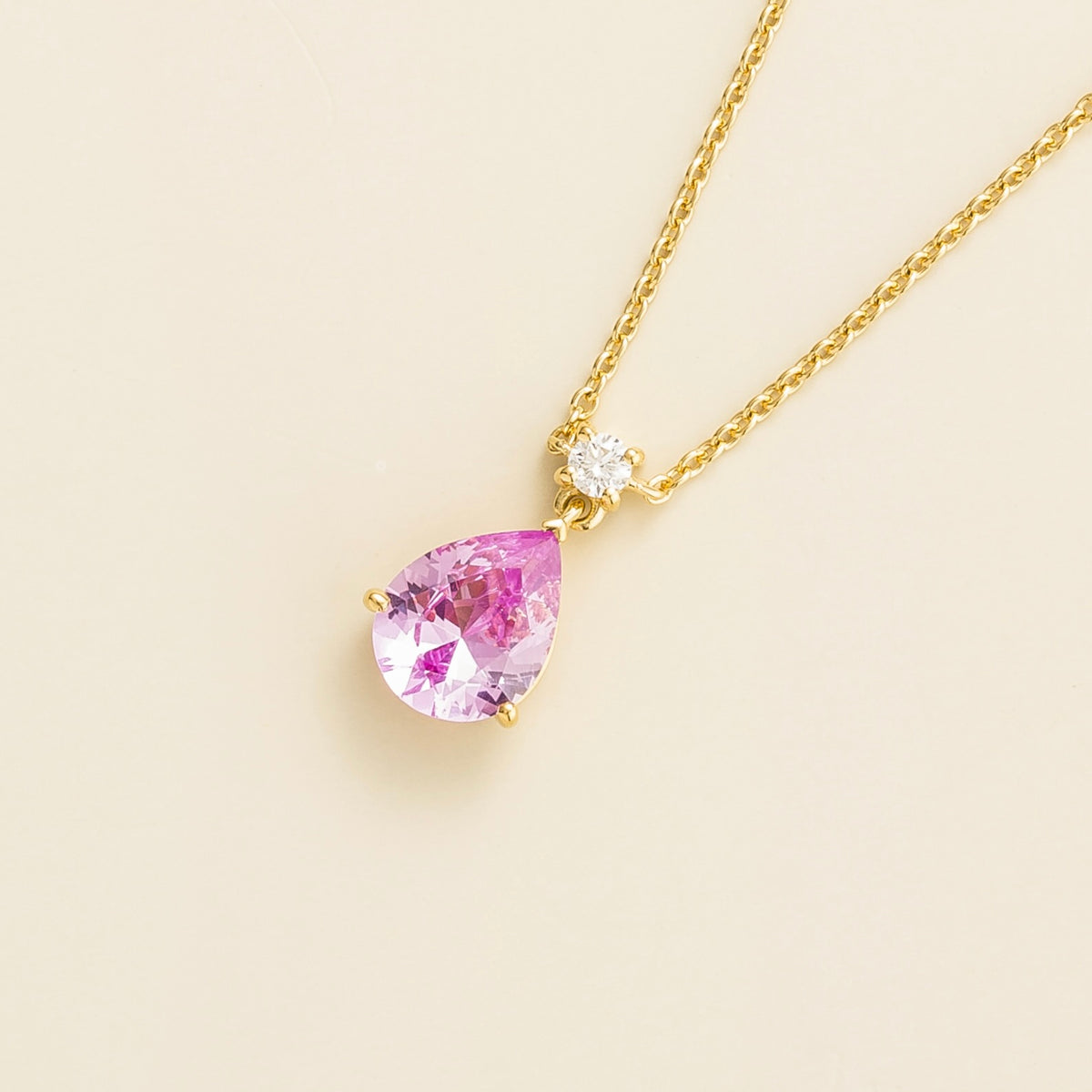 Lab-grown pink sapphire and diamond pear drop pendant necklace in gold, medium – angled view | Pisa by Juvetti