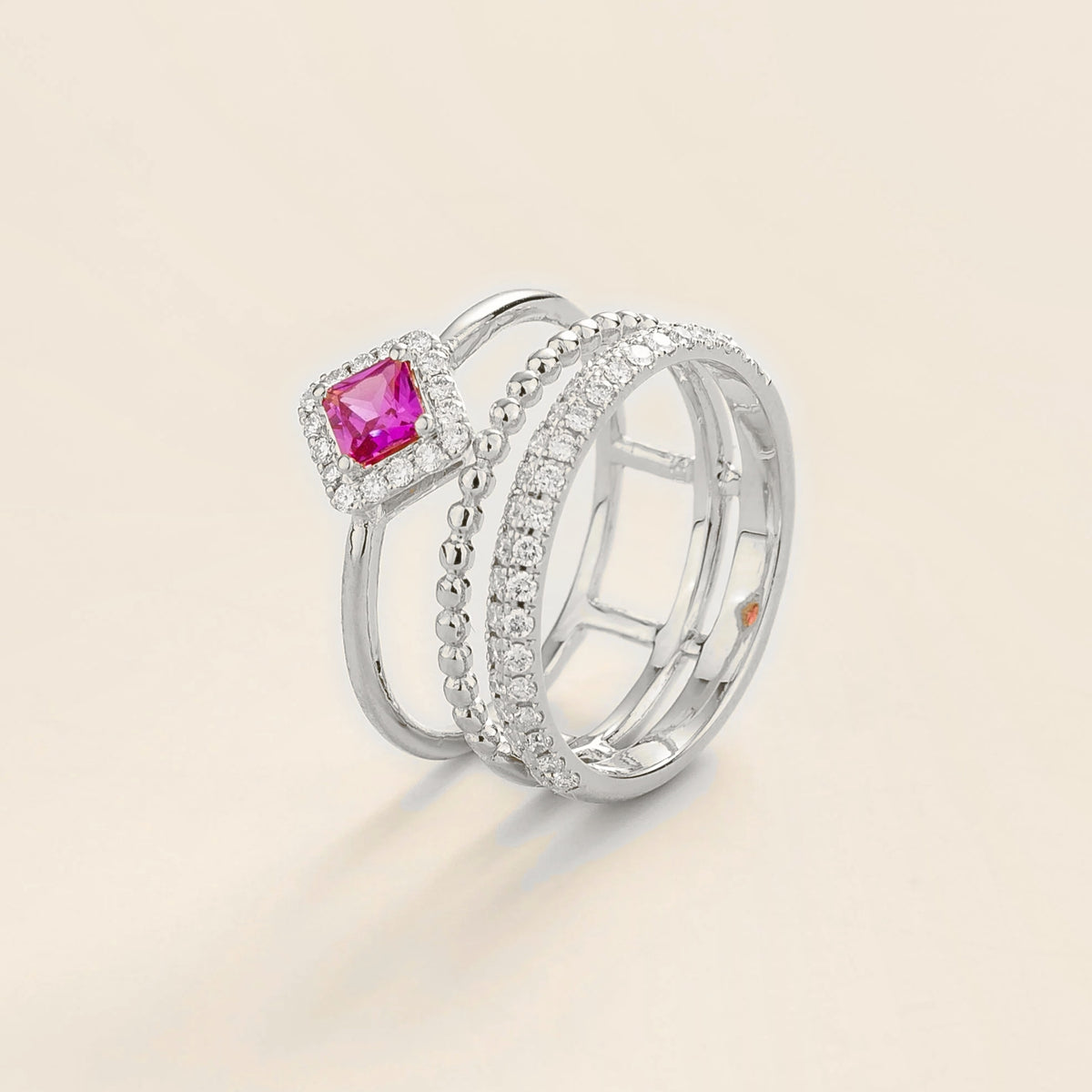 Amici triple-band stacking ring in white gold, princess-cut lab-grown pink sapphire in a diamond halo with beaded and pavé bands, side view | Juvetti London