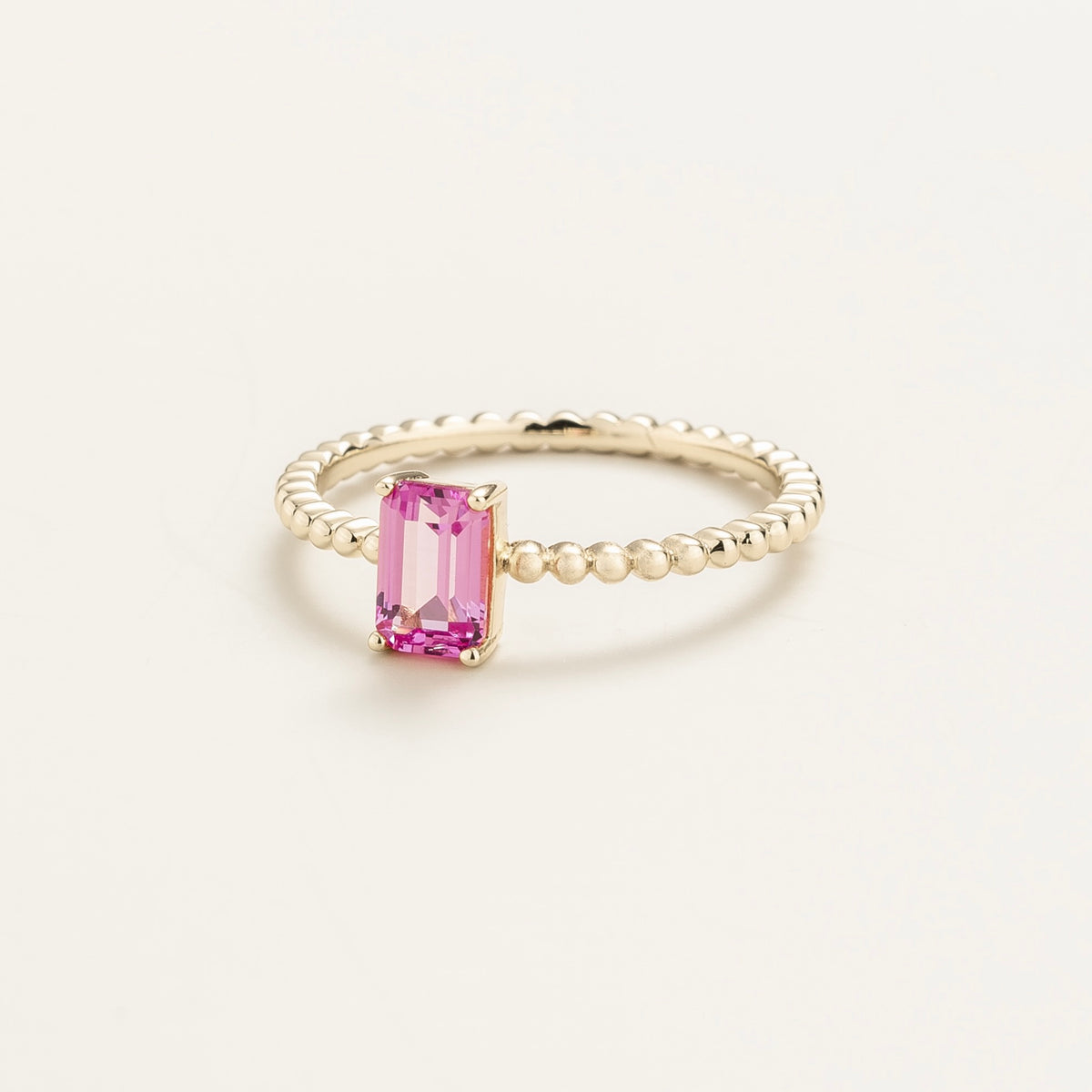 Fondi emerald-cut lab-grown pink sapphire beaded band ring in white gold – angle view | Juvetti London