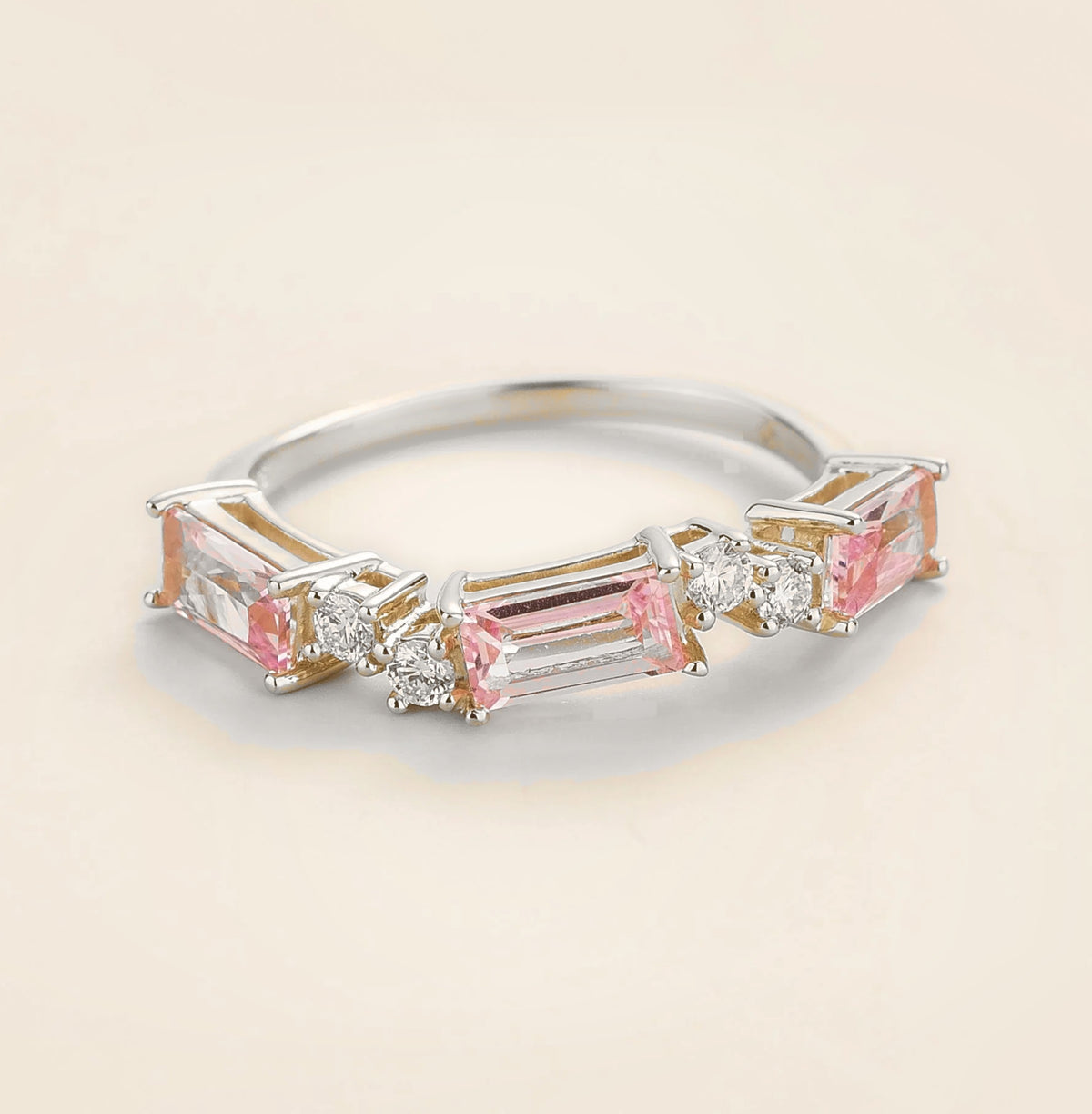 Juvetti white gold ring showcasing ethical lab-grown baguette-cut pink sapphires and round brilliant diamonds.