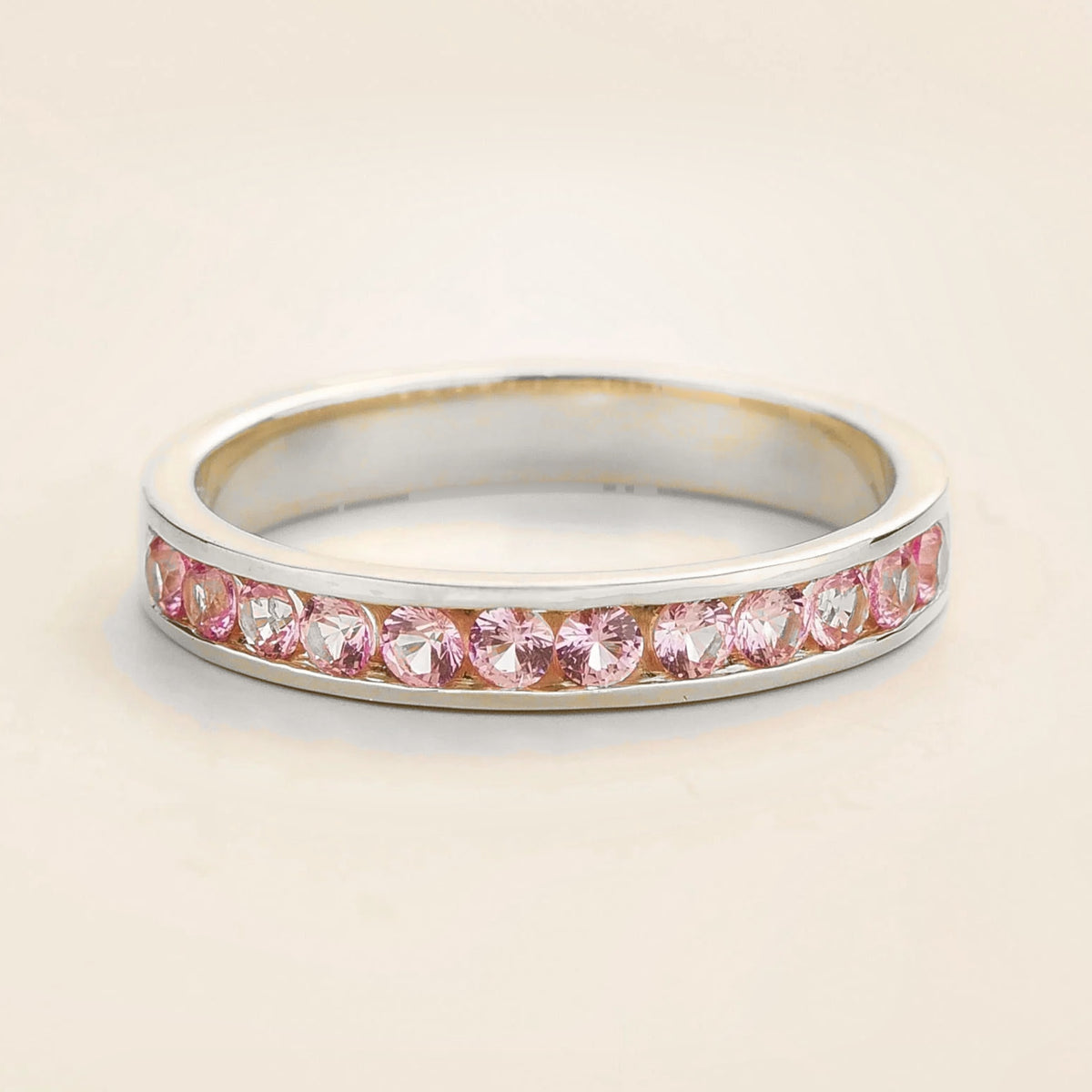 Juvetti white gold channel-set band featuring round lab-grown pink sapphires.