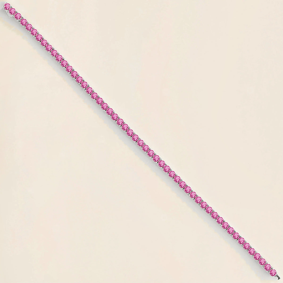 Round hot vivid pink sapphire tennis bracelet set in white gold