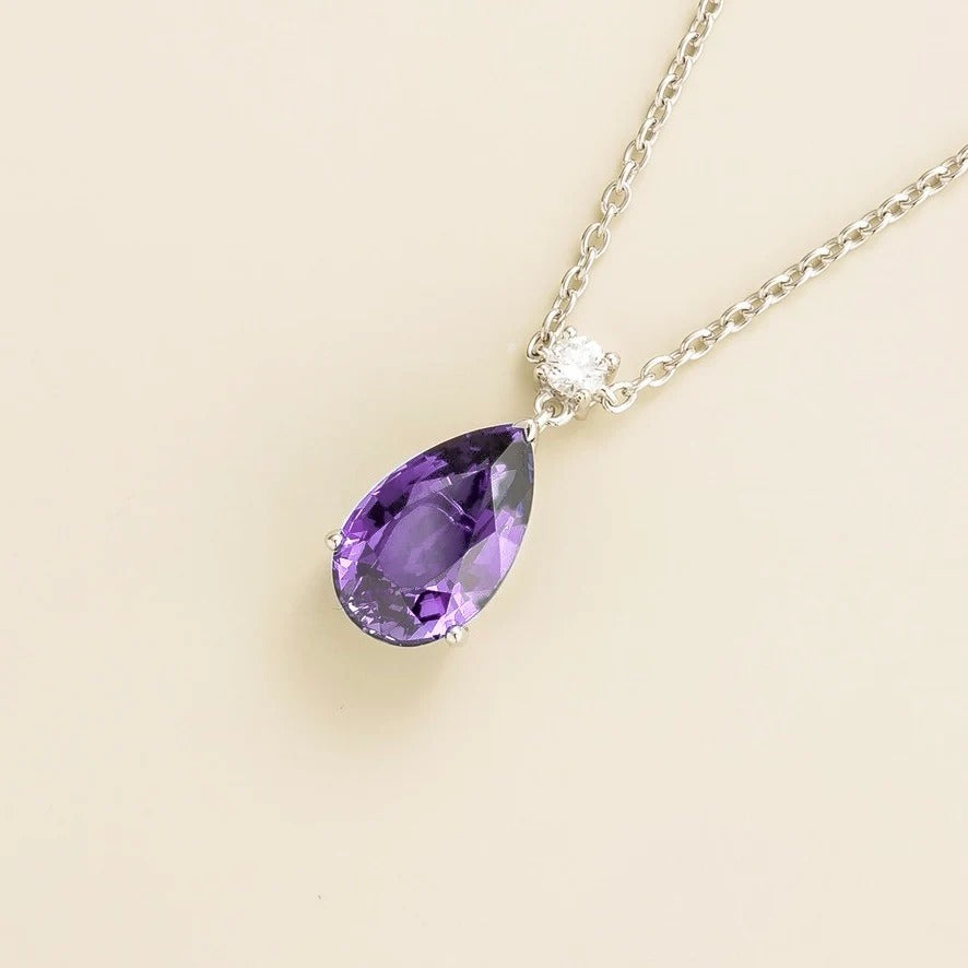 Side view of the Pisa large purple sapphire pear drop pendant necklace in white gold with diamond