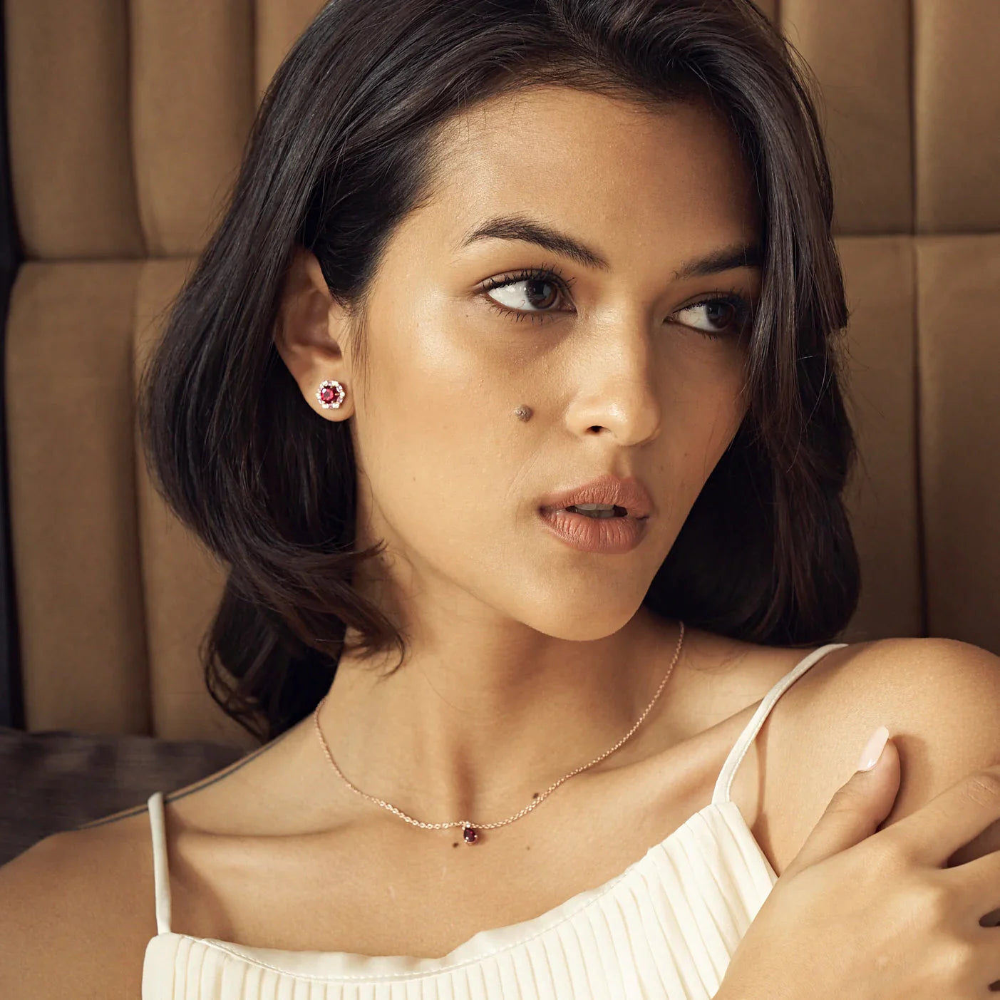 Model wears the Pisa pear ruby pendant necklace in gold
