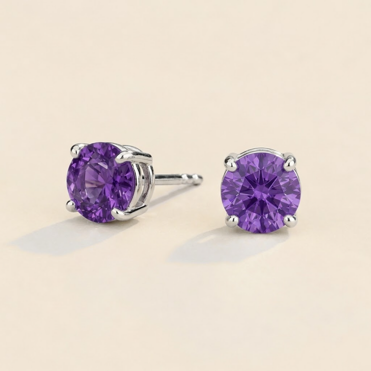 Nina round lab-grown purple sapphire solitaire stud earrings in white gold – angled view | Juvetti London