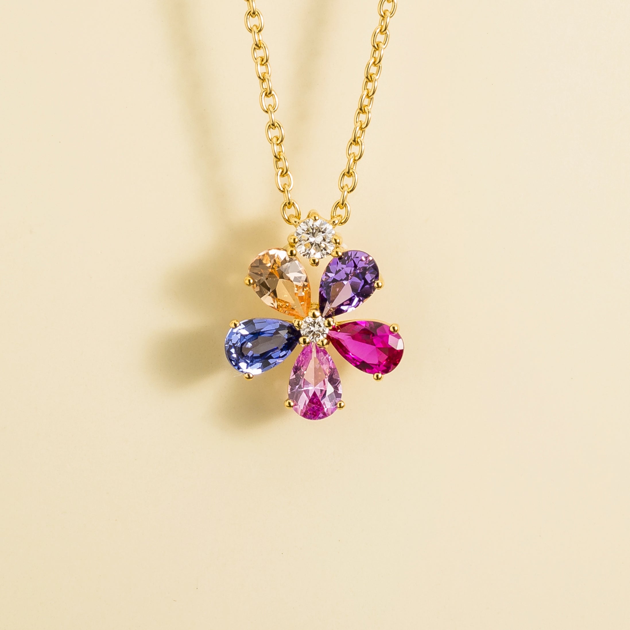 Front view of the Florea Blue Sapphire, Purple sapphire, Pink Sapphire, Champagne Sapphire & Diamond Flower Pendant Necklace in Gold, handcrafted by Juvetti London