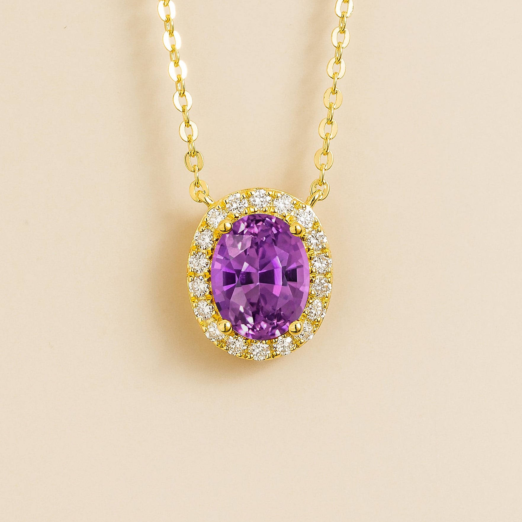 Front view of the Mina Oval Purple Sapphire & Diamond Halo Necklace In Gold, handcrafted by Juvetti London