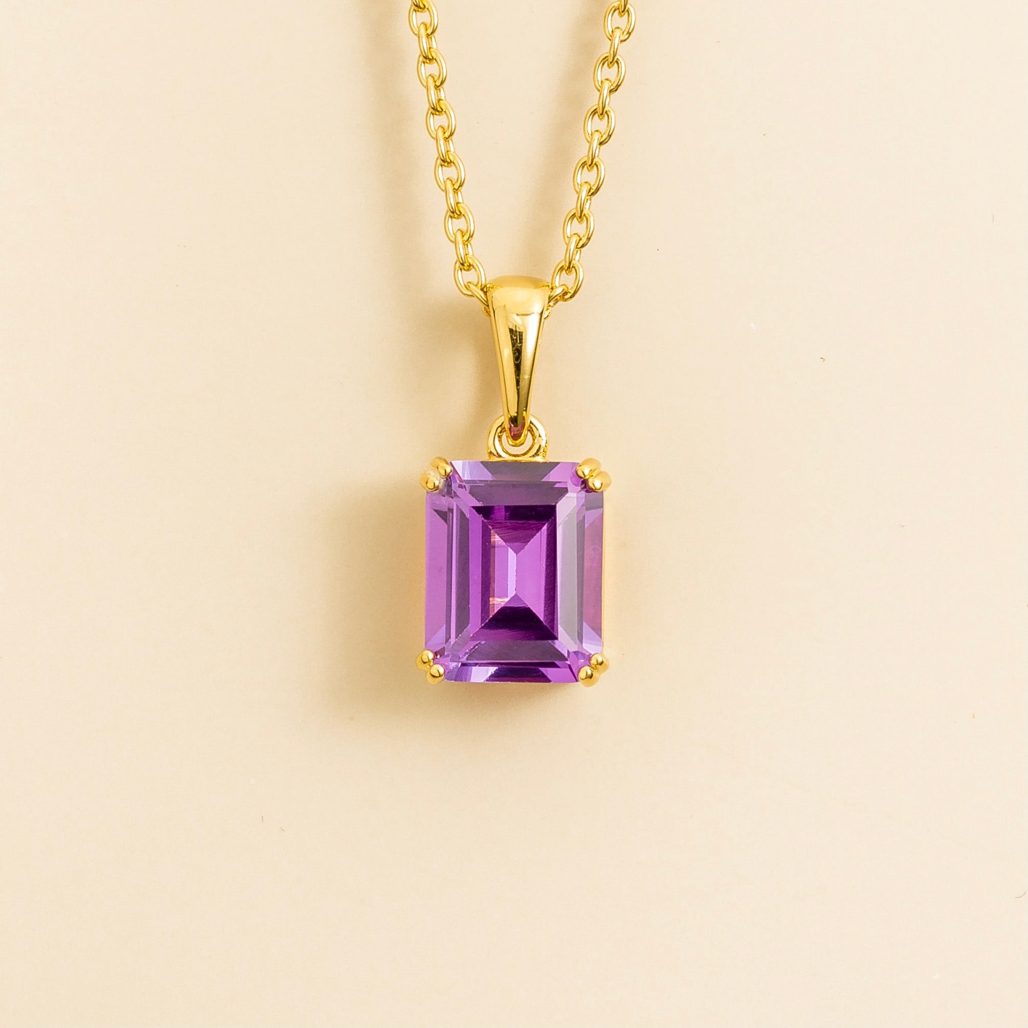 Front view of the Thamani Purple Sapphire Emerald-Cut Solitaire Pendant Necklace in Gold, handcrafted by Juvetti London