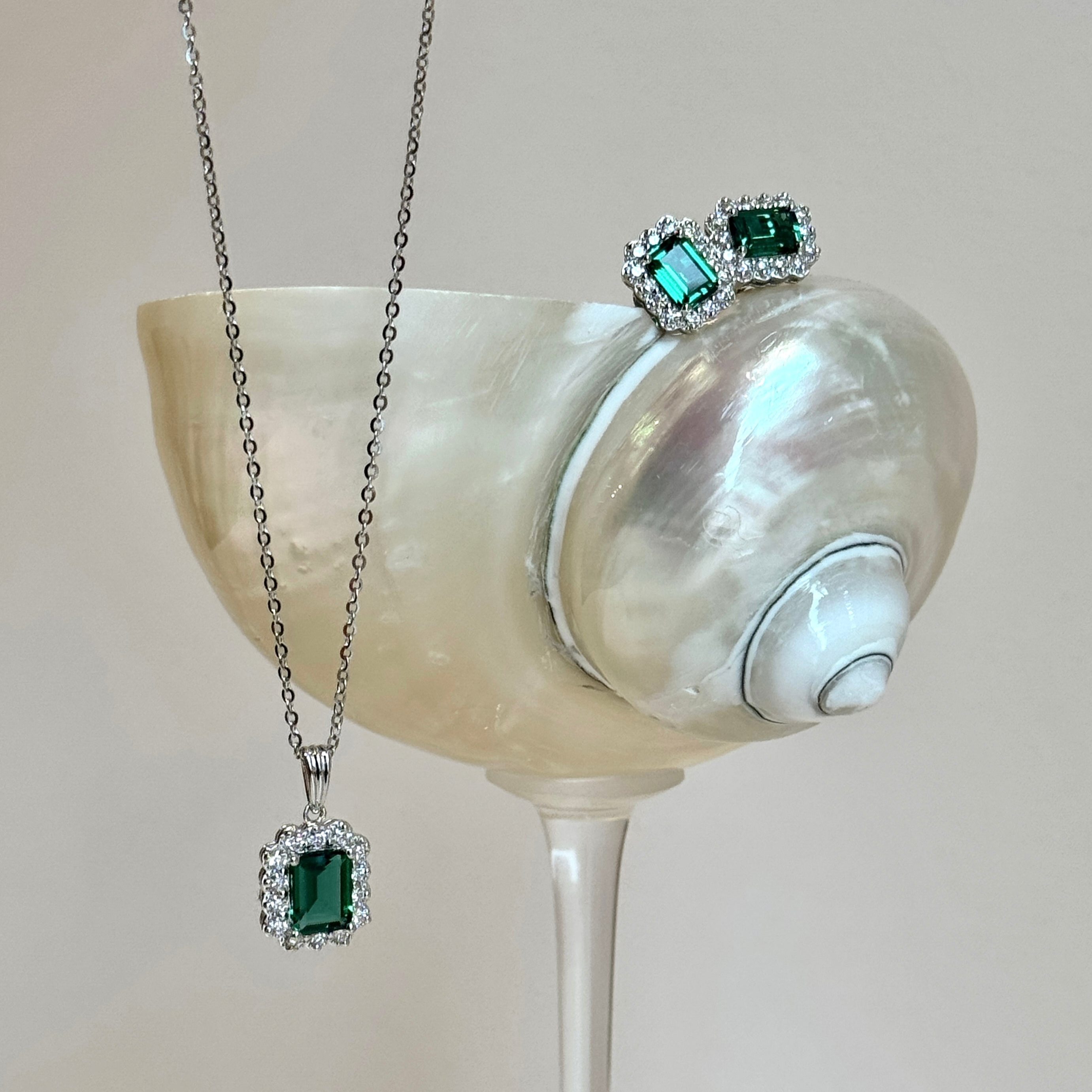 Pendant detail of the Verda Purple Sapphire Emerald-Cut & Diamond Halo Pendant Necklace in White Gold