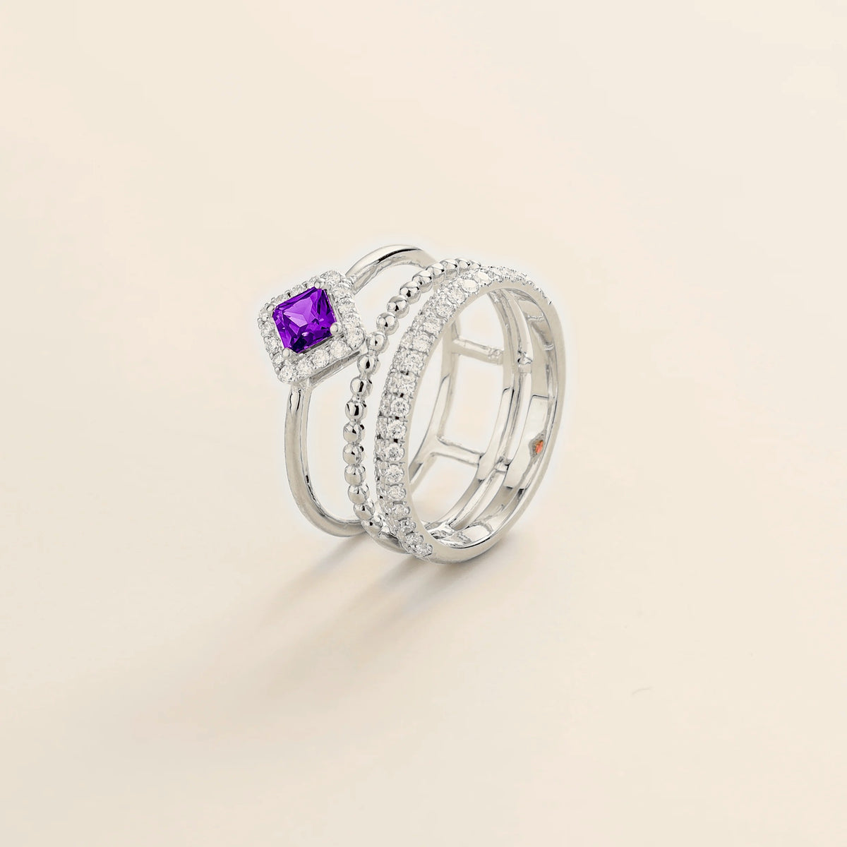 Amici triple-band stacking ring in white gold, princess-cut lab-grown purple sapphire in a diamond halo with beaded and pavé bands, side view | Juvetti London