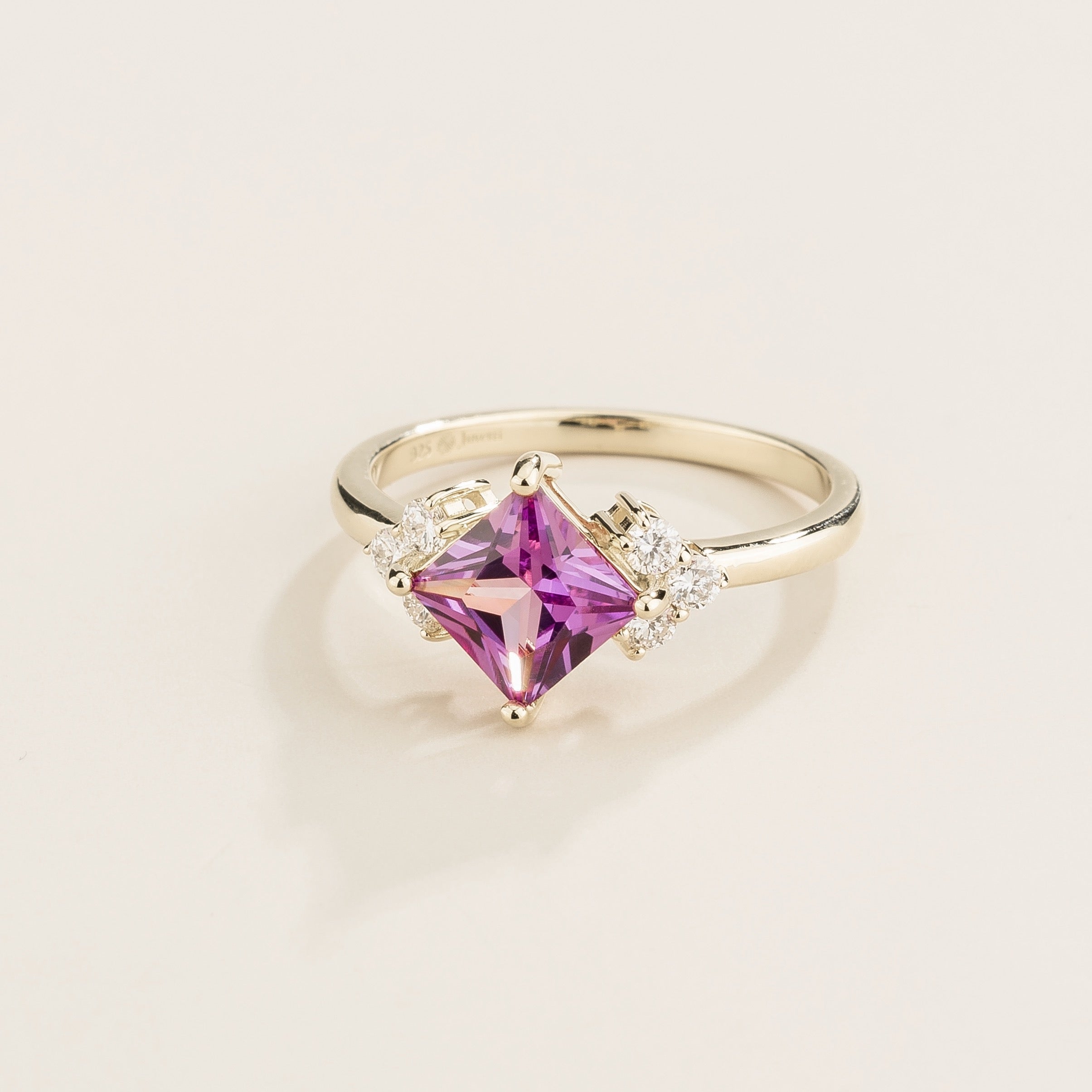 Angled view of the princess purple sapphire on the Amore ring in white gold, Juvetti jewellery