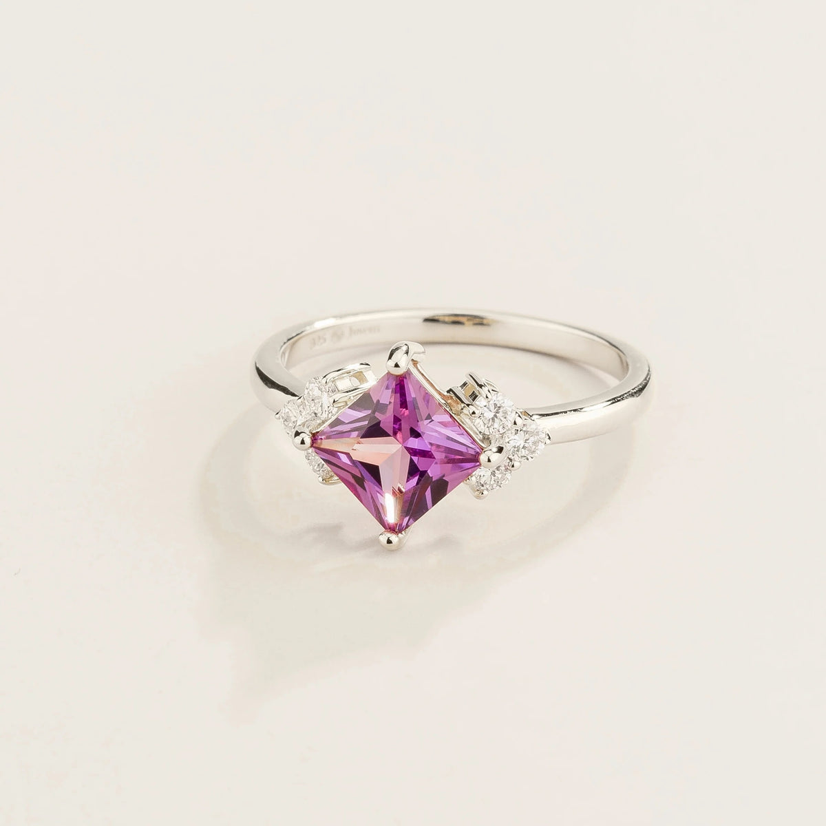 Angled view of the princess purple sapphire on the Amore ring in white gold, Juvetti jewellery