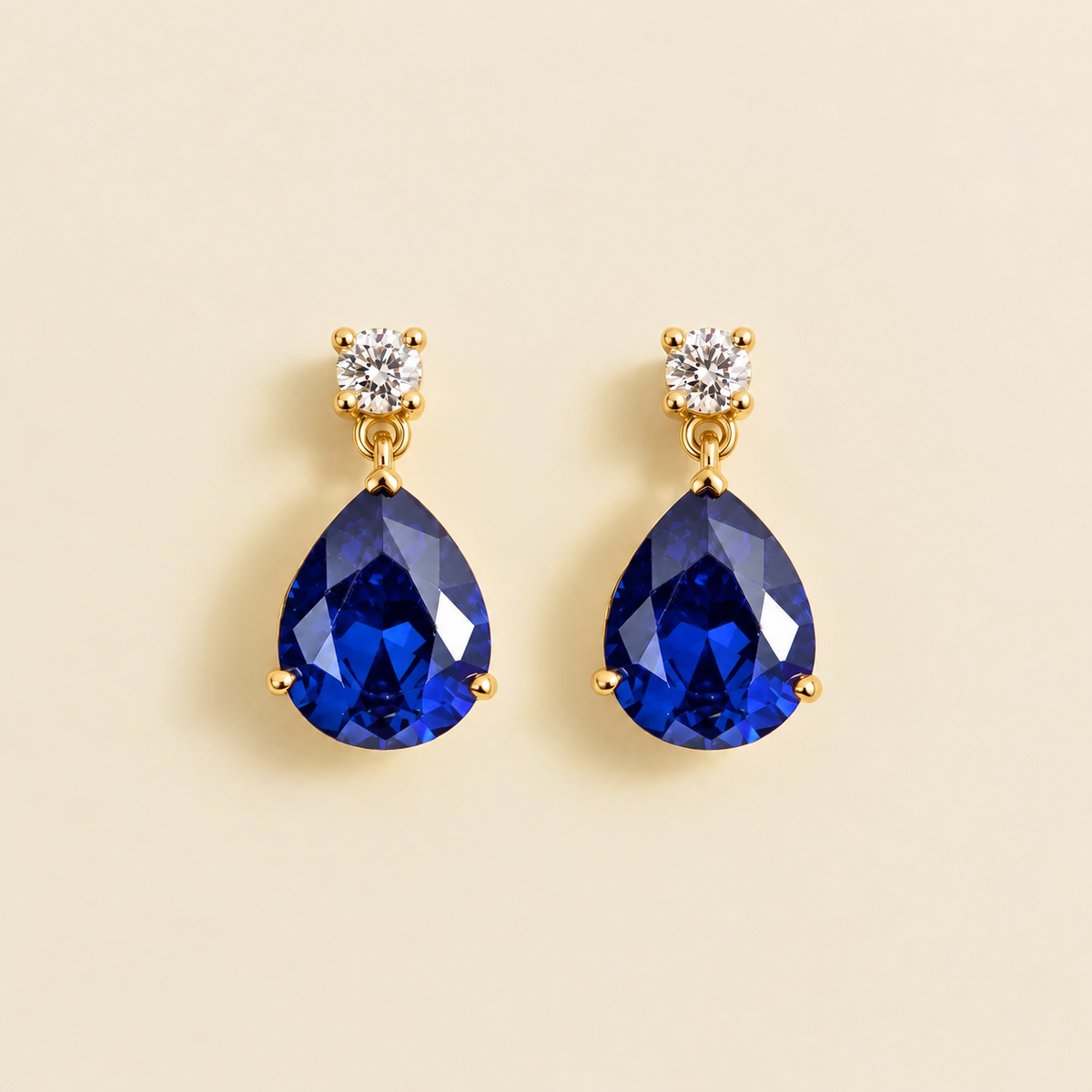 Medium lab-grown royal blue sapphire and diamond pear drop earrings in gold – front view | Pisa by Juvetti