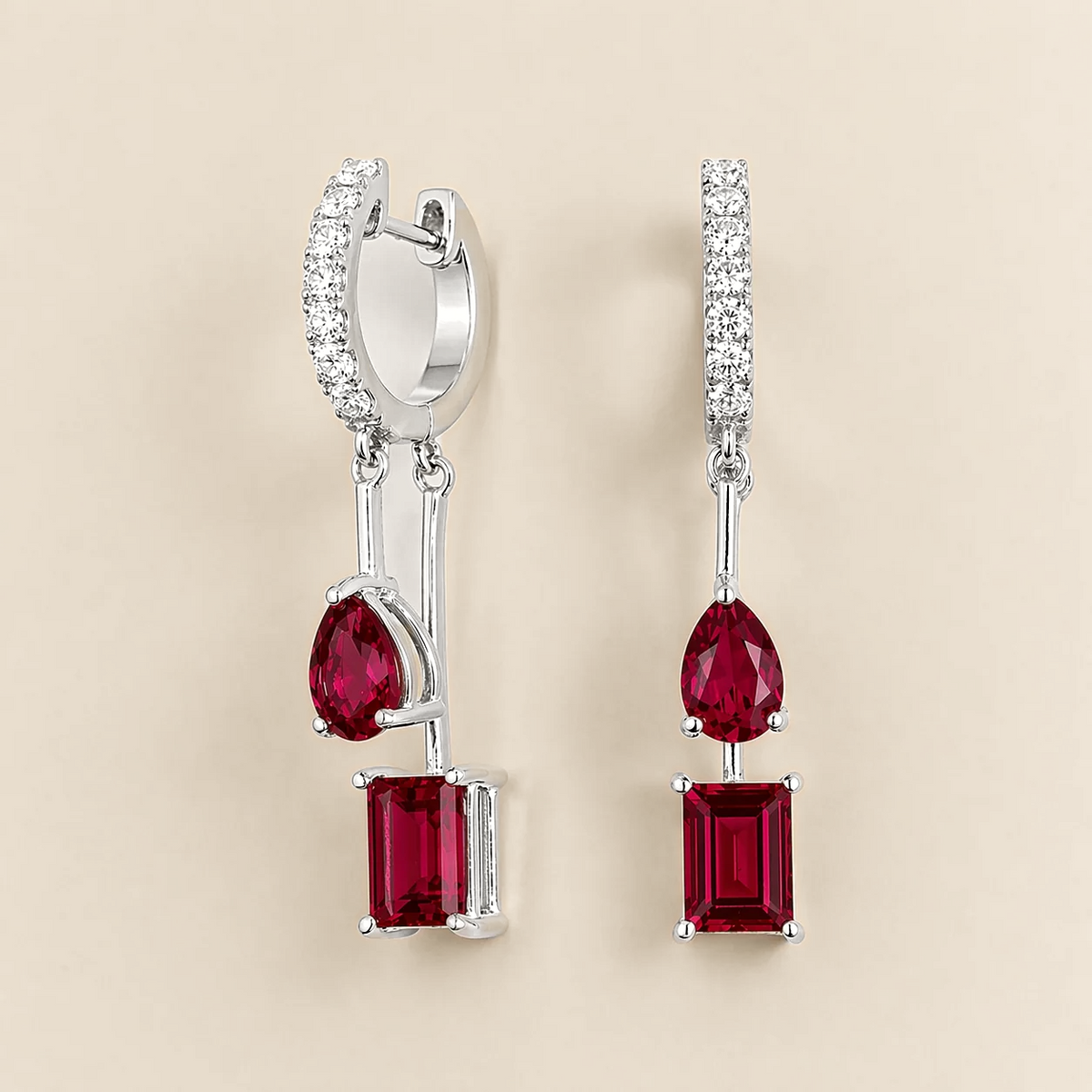Faire ruby huggie drop earrings in white gold, pear and baguette-cut lab-grown rubies with diamond pavé, front view | Juvetti London
