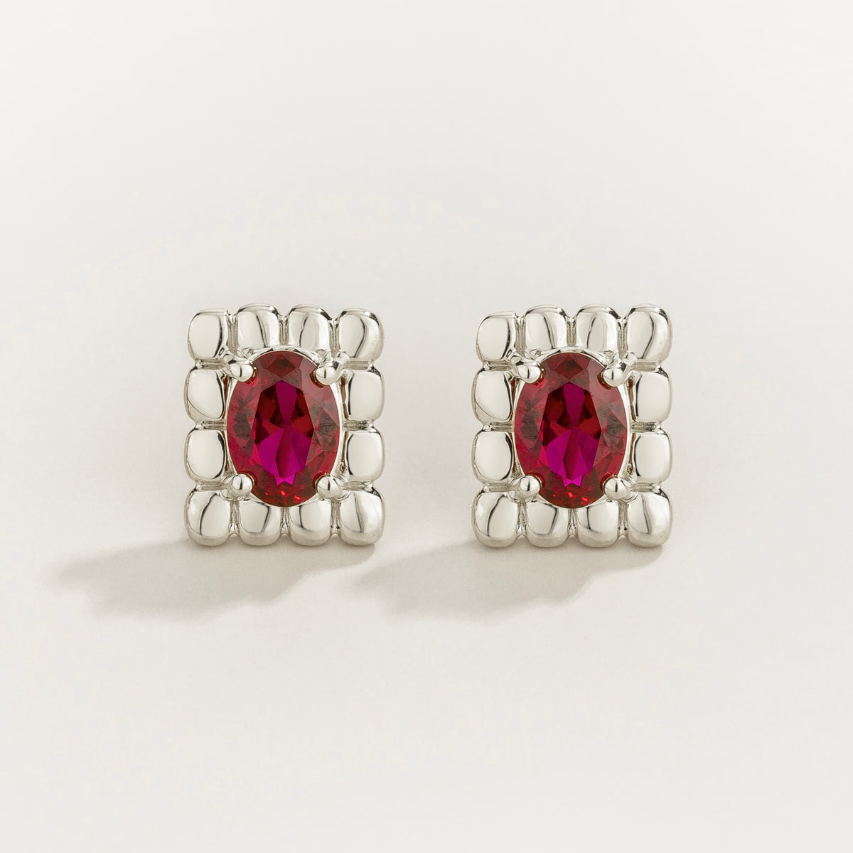 Fondi oval lab-grown ruby sculpted stud earrings in white gold – front view | Juvetti London