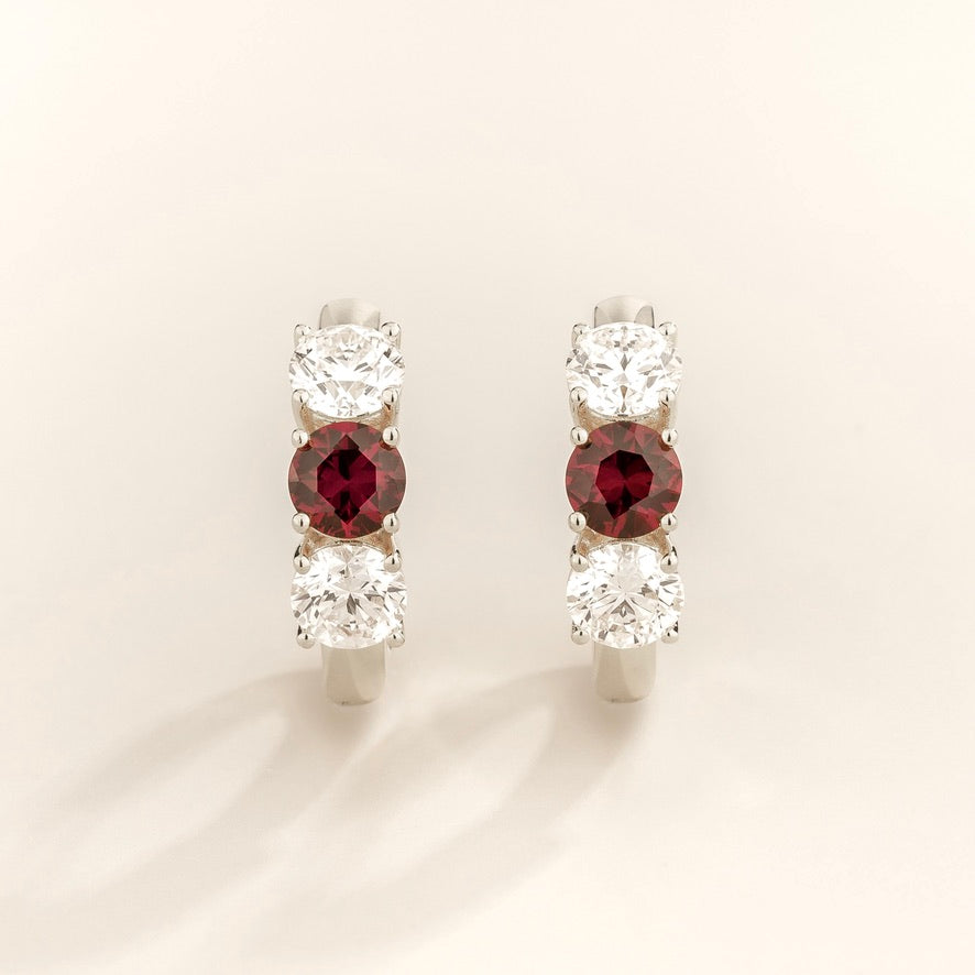 Tres Ruby Three-Stone Huggie Hoop Earrings in White Gold – close-up
